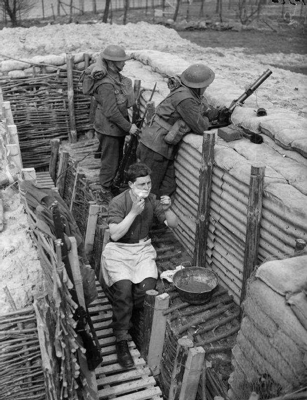 Men of D Company, 2nd Sherwood Foresters, UK 1st Division in a forward trench near Roches, France, 1 Apr 1940; Lance Corporal L. J. Harris seen shaving