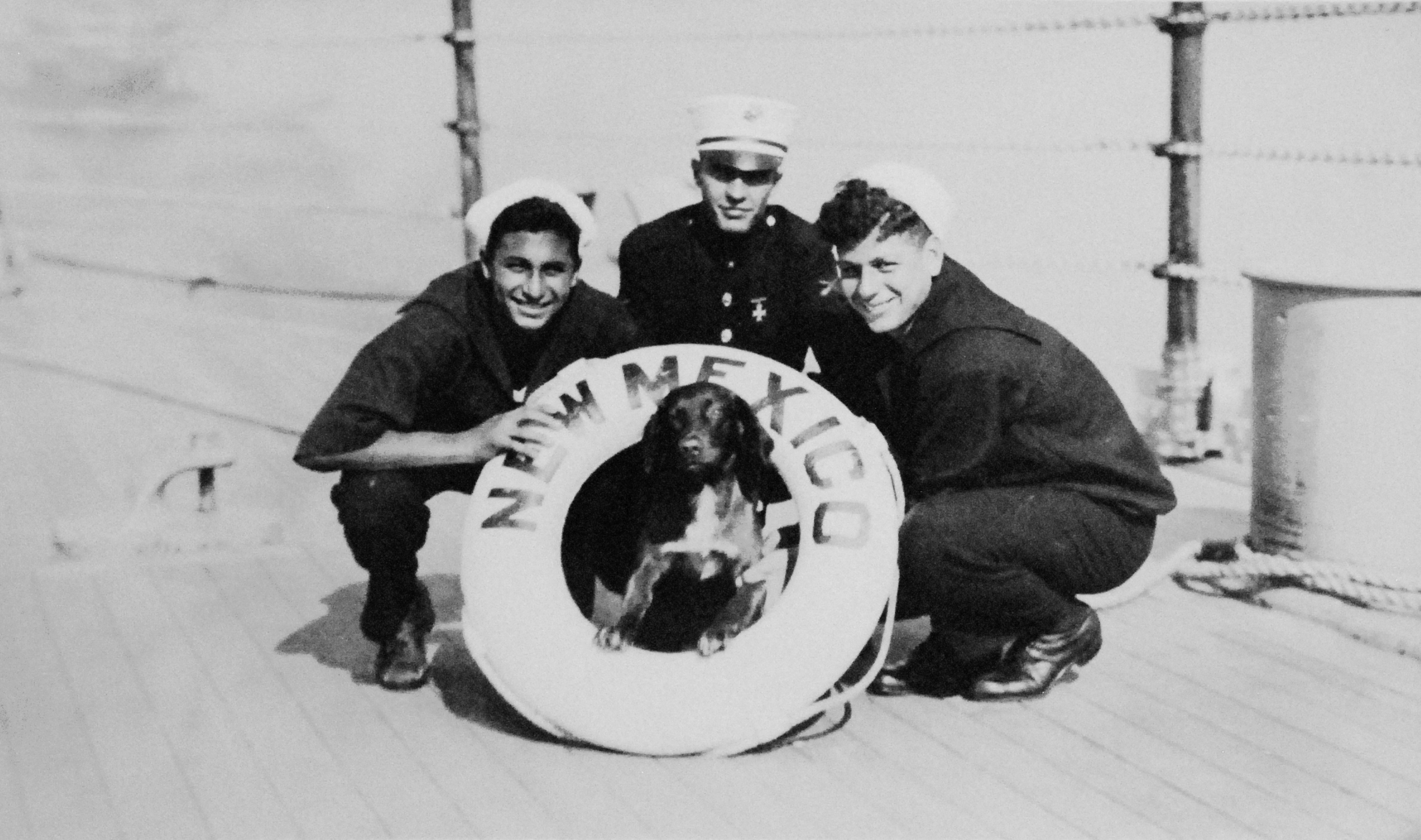 A US Marine and two US Navy sailors with USS New Mexico's mascot dog, circa 1919