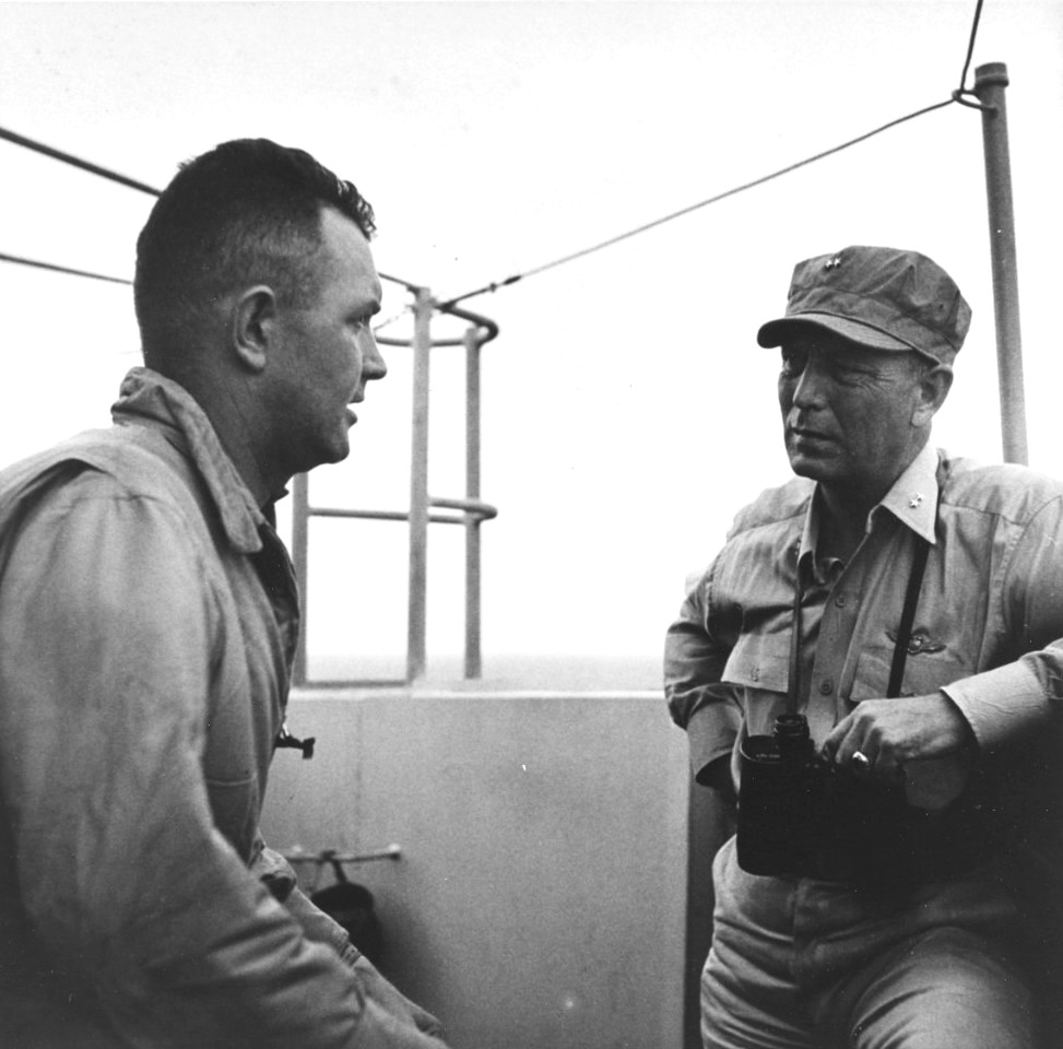 Commander Air Group 80, Lt Commander Albert O. Vorse, discussing the results of the 6 Nov 1944 raid on Manila with Rear Admiral Arthur W. Radford, right, aboard the USS Ticonderoga.
