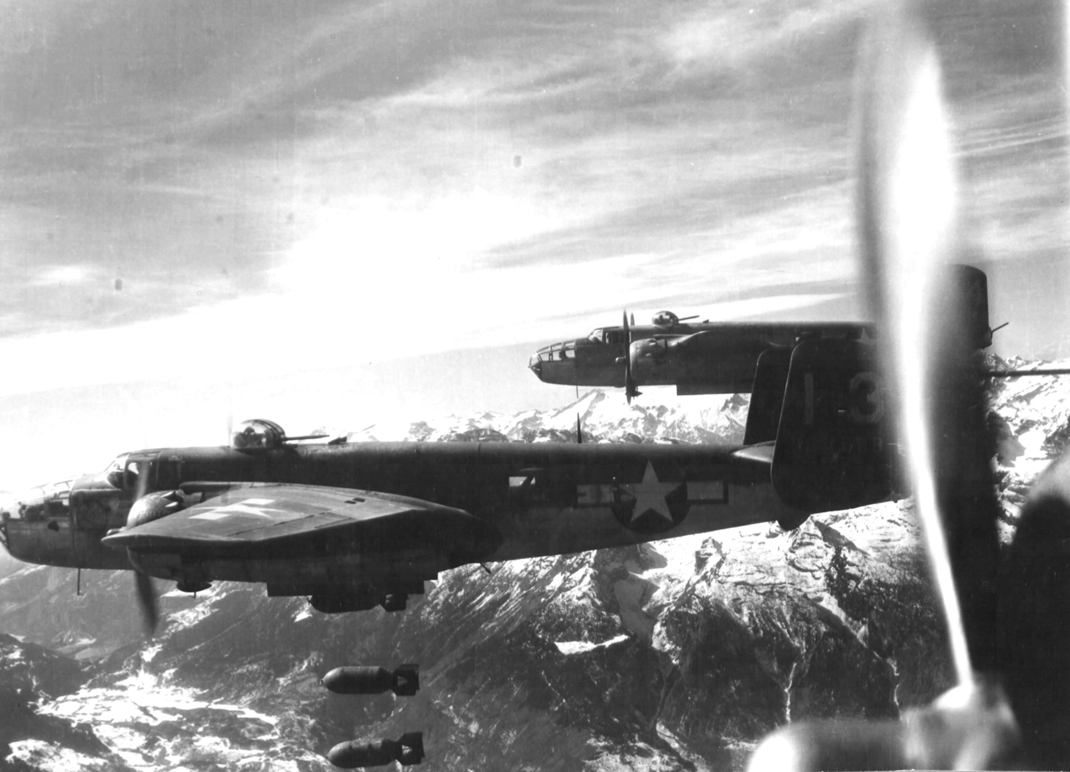 B-25 Mitchell bomber “Peggy Lou” and other B-25s of the 321st Bomb Group flying from Solenzara, Corsica bombing San Michele railroad bridge in the Brenner Pass region of northern Italy, 10 Mar 1945.
