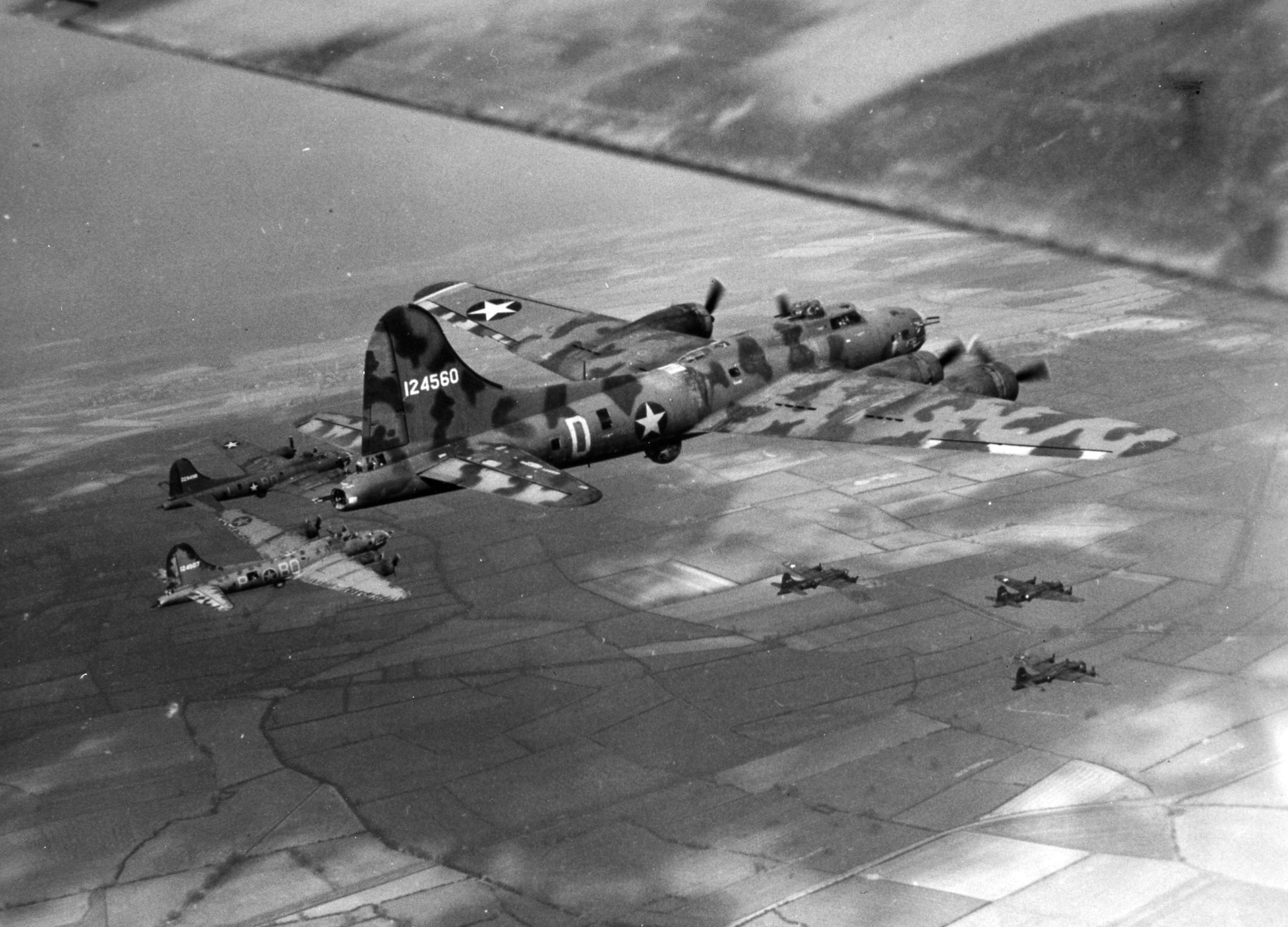 Boeing B-17F Fortress “Little Audrey” flying with other bombers of the 306th Bomb Group based at Thurleigh, Bedfordshire, England, United Kingdom, May or Jun 1943. Note the unusual camouflage paint scheme.