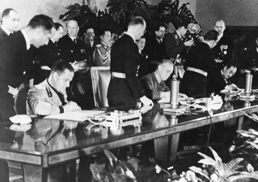 The signing of the Tripartite Pact at the Reich Chancellery in Berlin, 27 Sep 1940.  The signers are, left to right, Galeazzo Ciano of Italy, Joachim von Ribbentrop of Germany, and Saburō Kurusu of Japan.