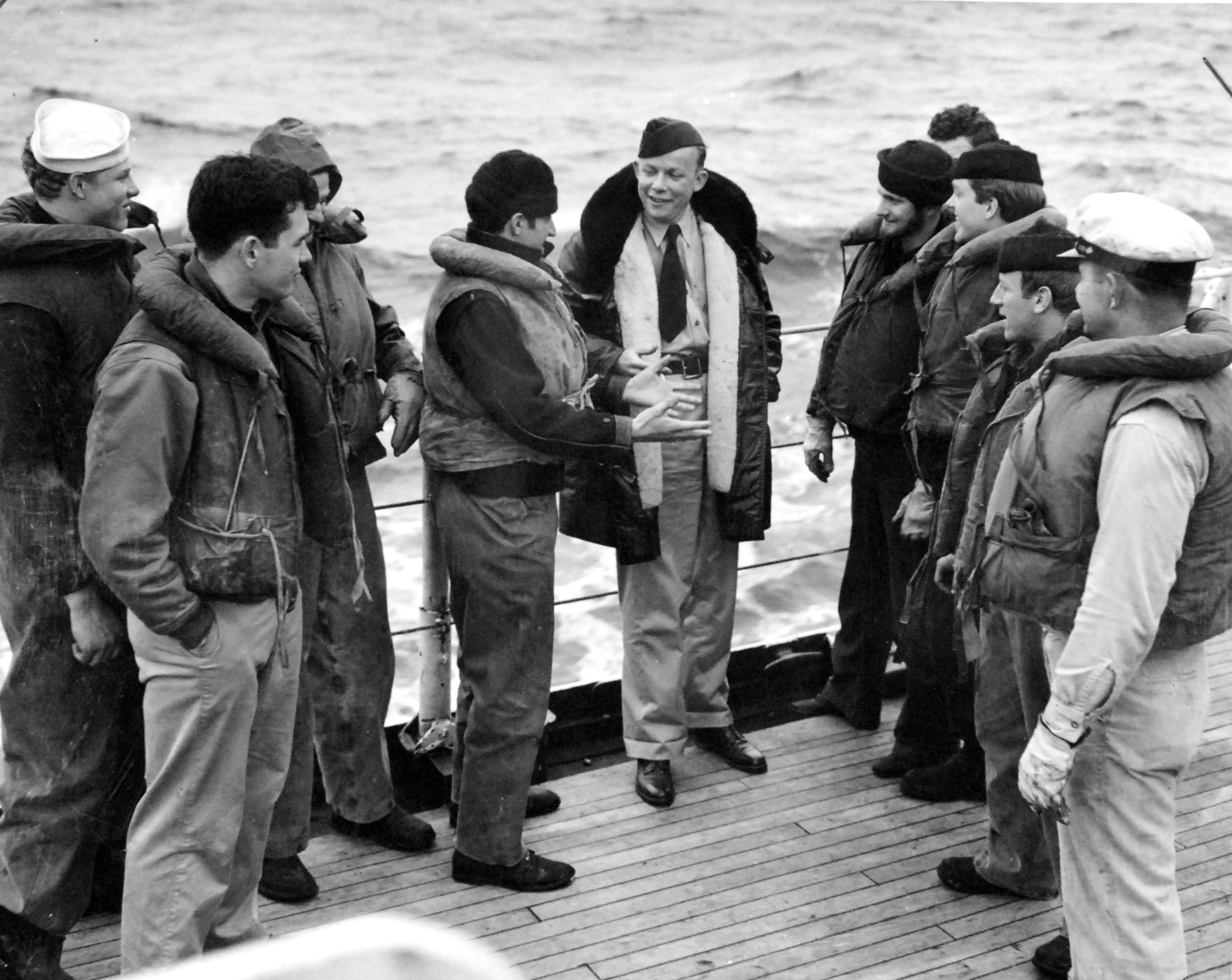 Time Magazine war correspondent William Walton, in the expensive coat, speaking with crewmen aboard the Coast Guard cutter Spencer, early 1943 in the Atlantic.