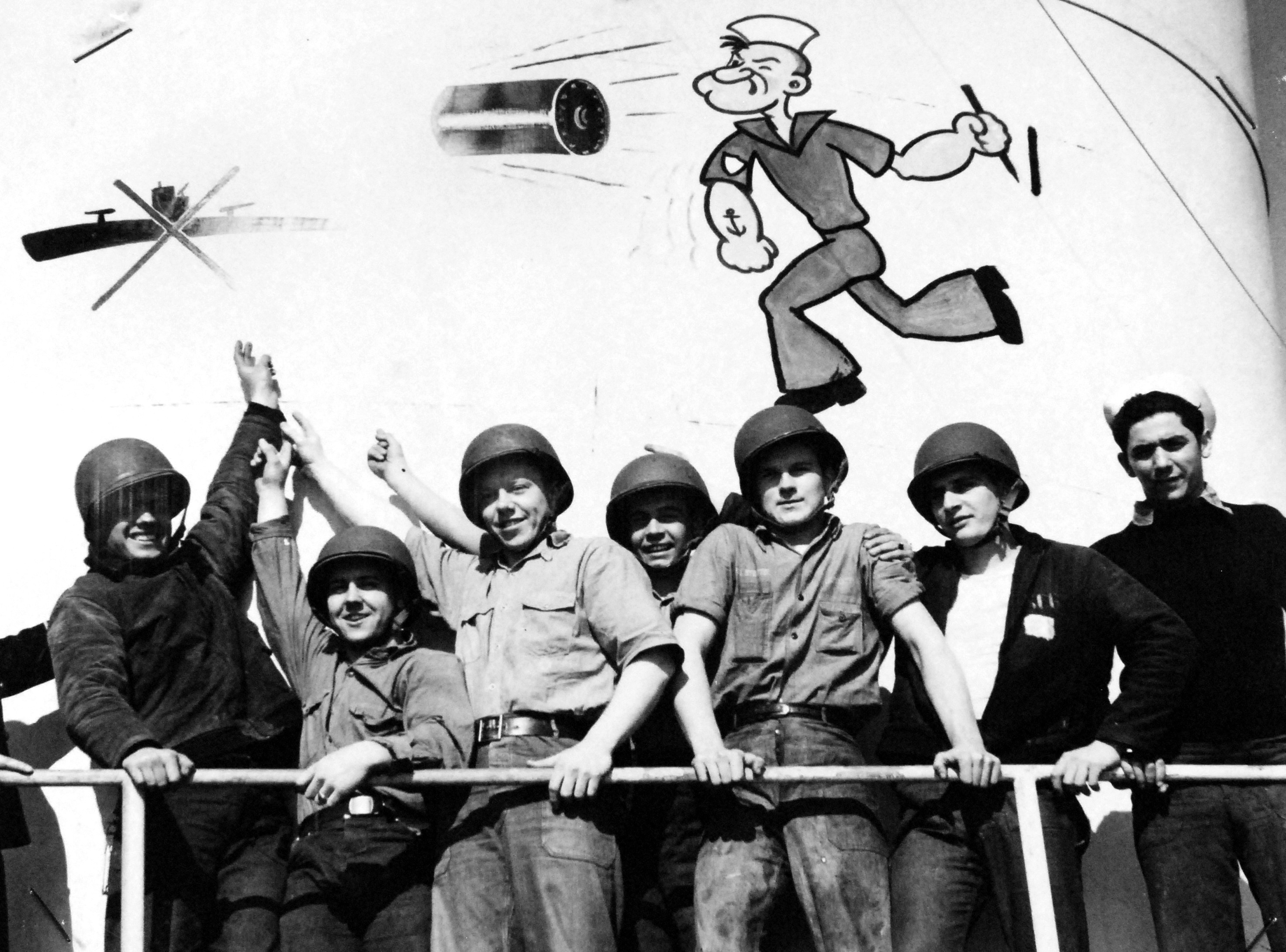 Crewmen of the United States Coast Guard cutter Spencer celebrating the new artwork on the ship’s funnel commemorating Spencer’s sinking of U-175 by depth charge in the North Atlantic.