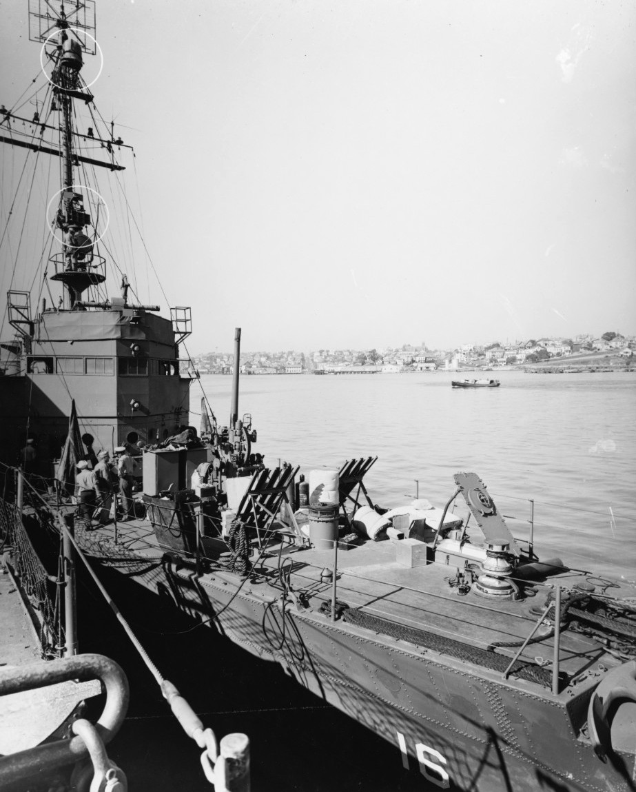 High Speed Minesweeper USS Trever alongside the pier at Mare Island Naval Shipyard, 2 Dec 1943. Note the raised Mousetrap anti-submarine rocket rails on the foredeck.