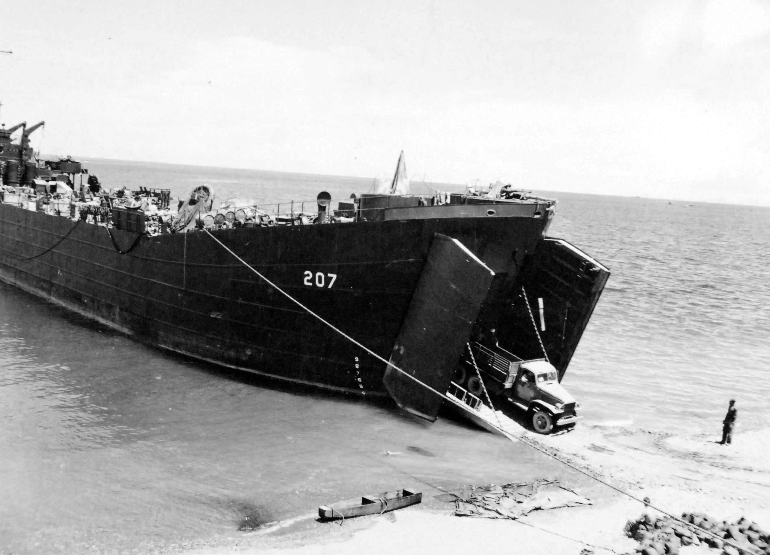 United States Navy ship LST-207, staffed by Coast Guard personnel, on Kukum Beach, Guadalcanal, Solomon Islands, 26 Nov 1943.