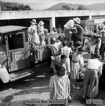 Recently freed internees of Stanley Internment Camp boarding lorries which would take them to ships for their trips to Europe, Hong Kong, 18 Sep 1945