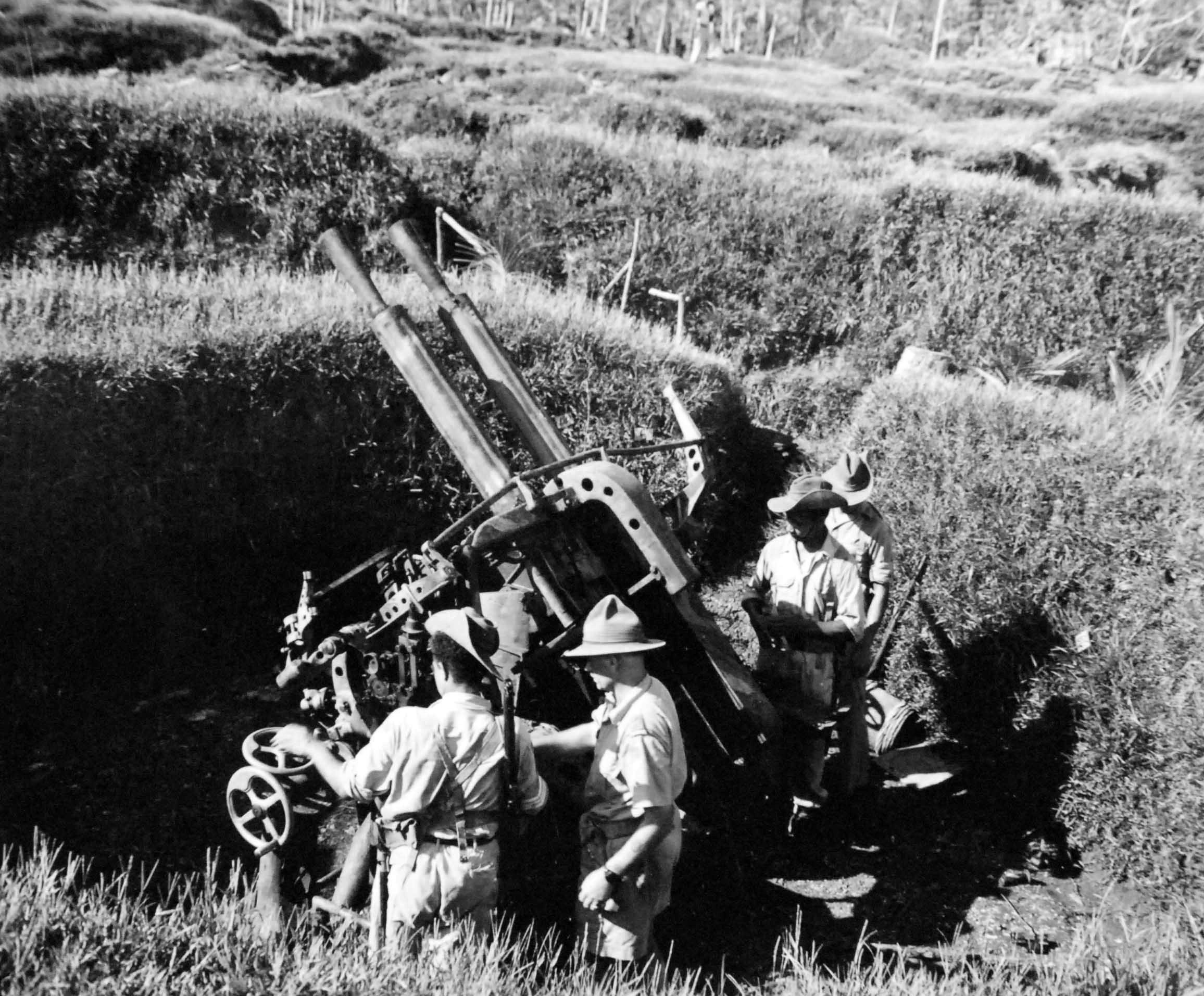 Australian troops inspecting a captured Japanese Type 91 40mm anti-aircraft gun on Kolombangara, Solomon Islands, 1943.