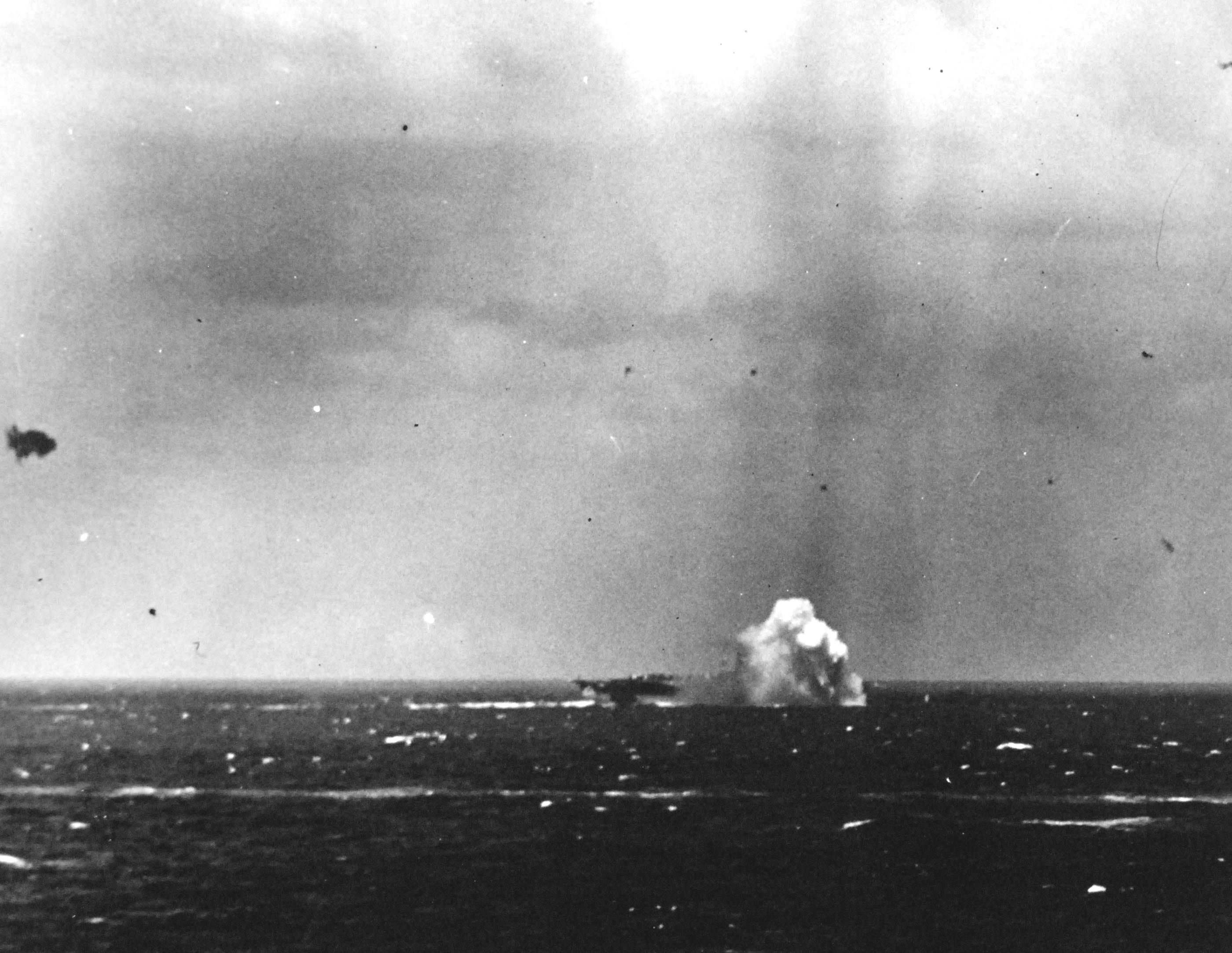 A Japanese special attack A6M aircraft crashing close aboard the starboard side of the carrier Ticonderoga off the Philippines, 5 Nov 1944. Photo 2 of 3.
