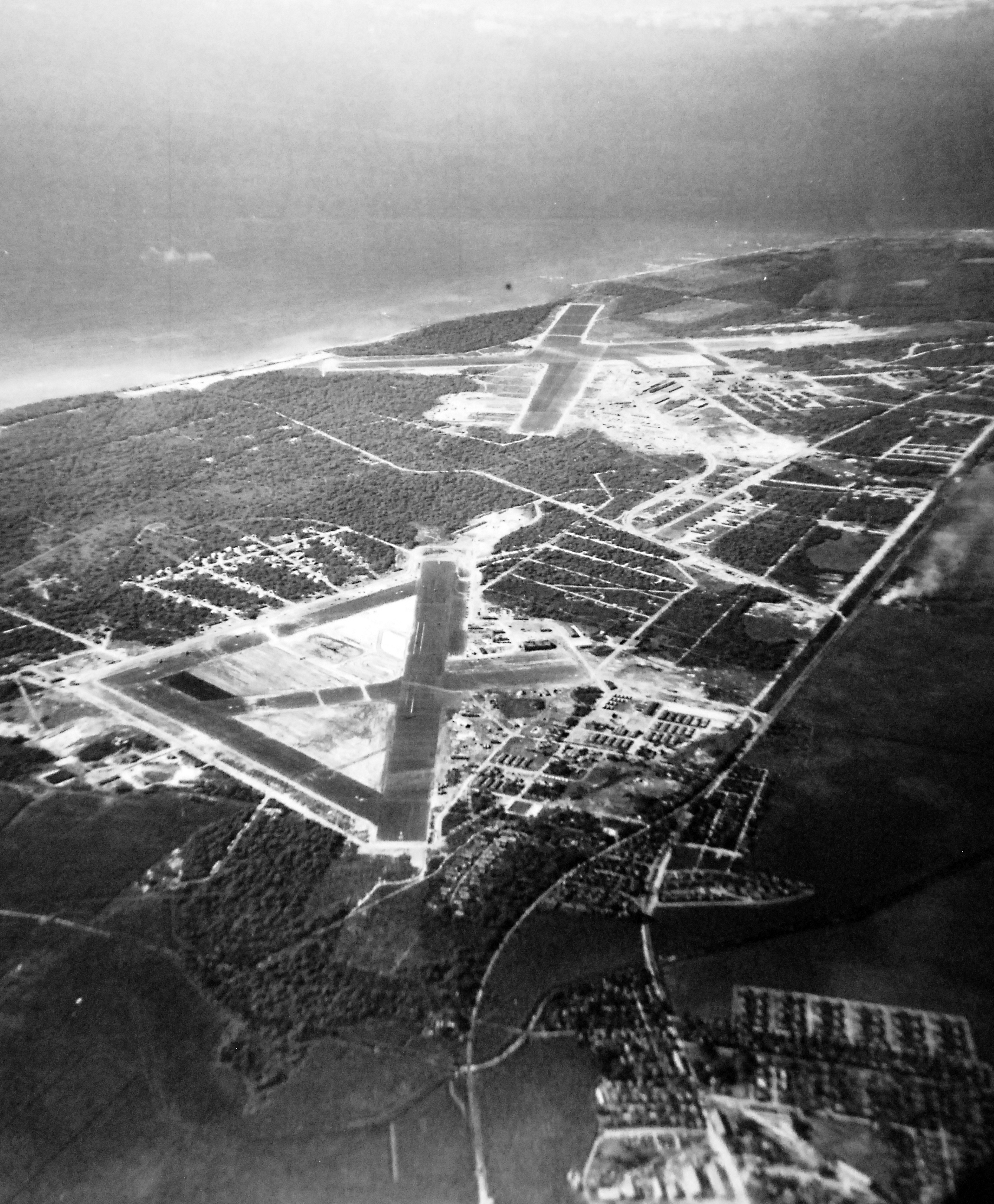 Aerial view of Ewa Field (near) and Barbers Point Naval Air Station (beyond) on Oahu, Hawaii, 20 Jan 1943.