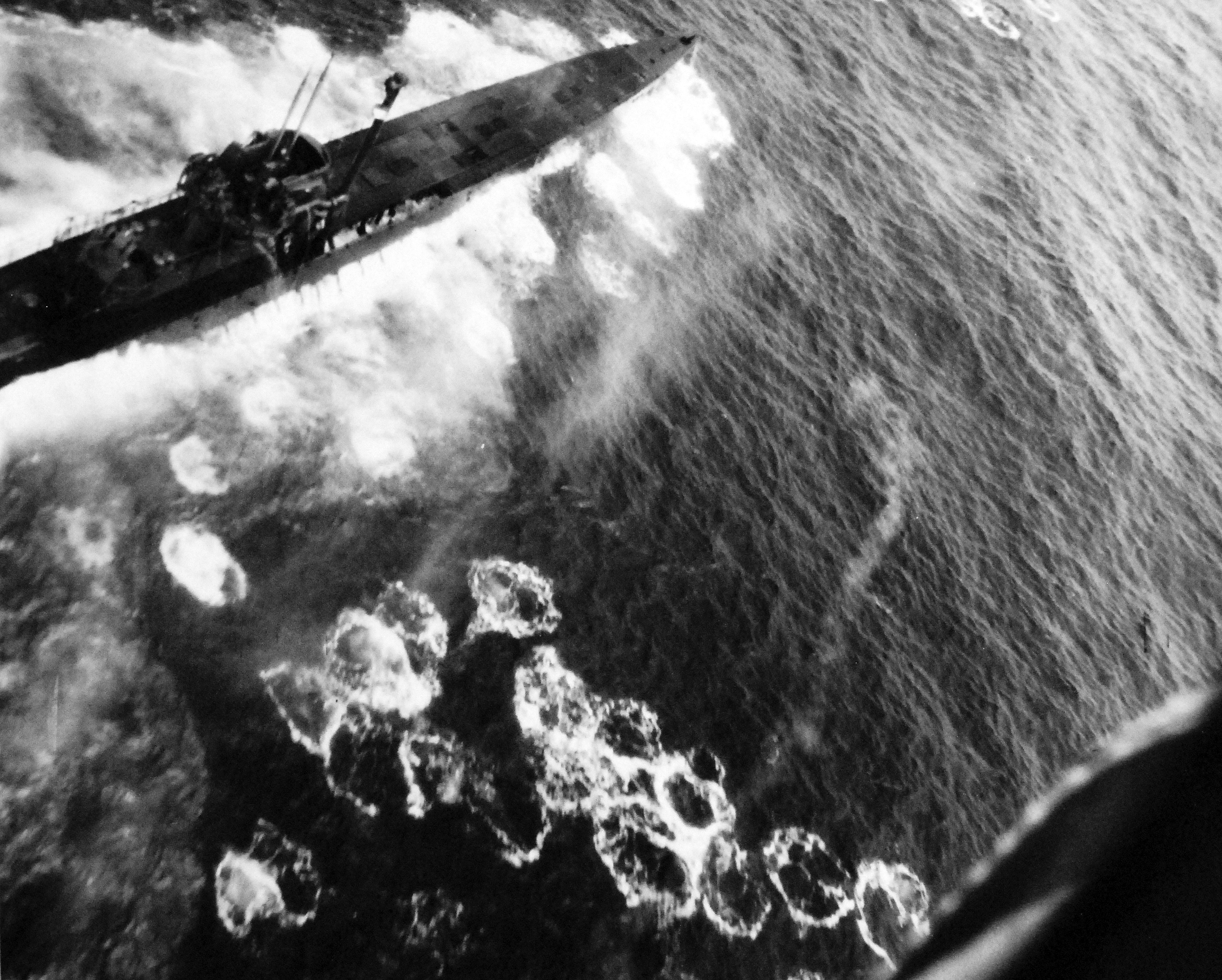 Air Attack on German submarine U-1229 by Lt(jg) Bernard Sissler flying from USS Bogue, 20 Aug 1944. The submarine was sunk with 18 killed and 41 surviving. Note the raised “Schnorkel” device.