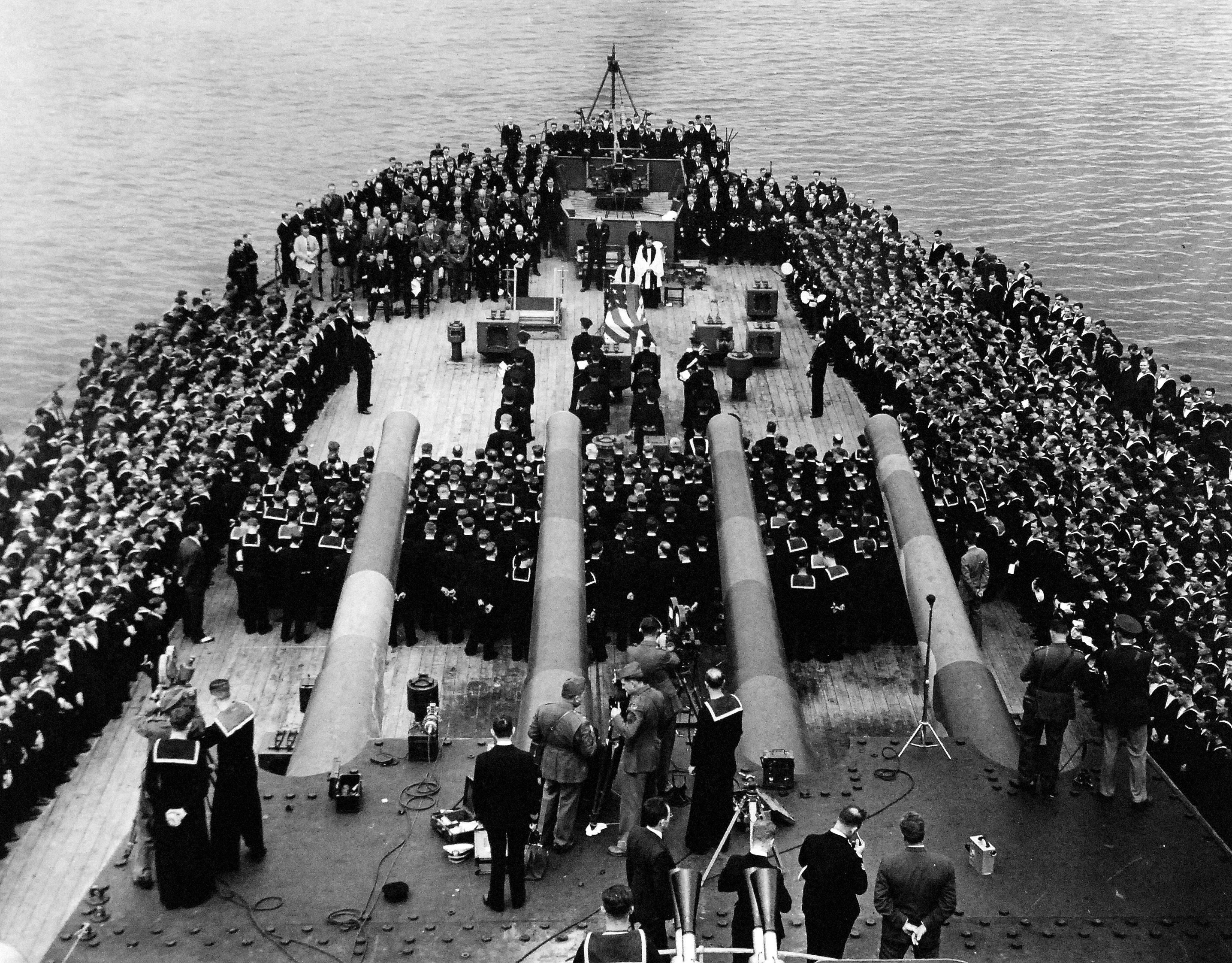 Religious services on the fantail of HMS Prince of Wales during the Atlantic Conference, Placentia Bay, Newfoundland, 10 Aug 1941. Note Prince of Wales’ 10-inch guns and Roosevelt and Churchill seated to the left.