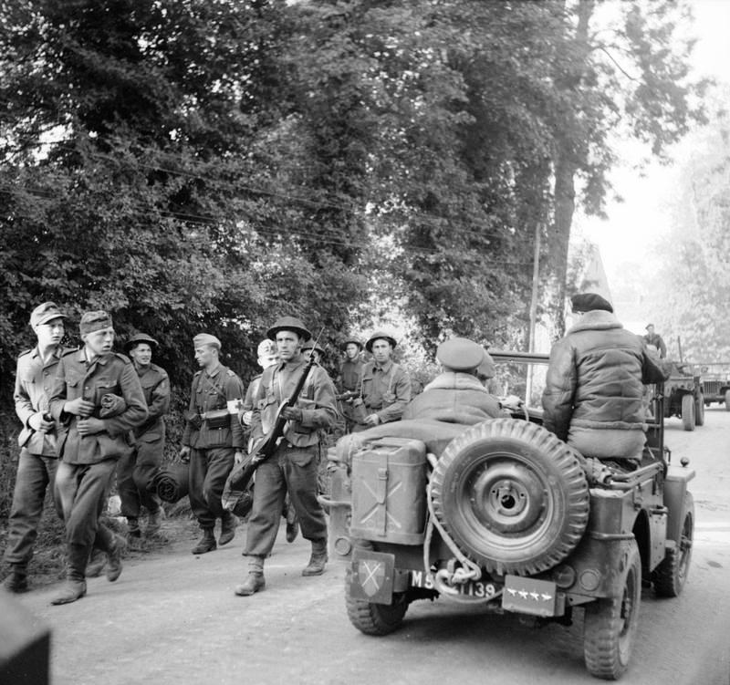 Shortly after arriving in Normandy, France, General Bernard Montgomery’s Jeep stopped so he could examine German prisoners being marched toward the beach, 8 Jun 1944.