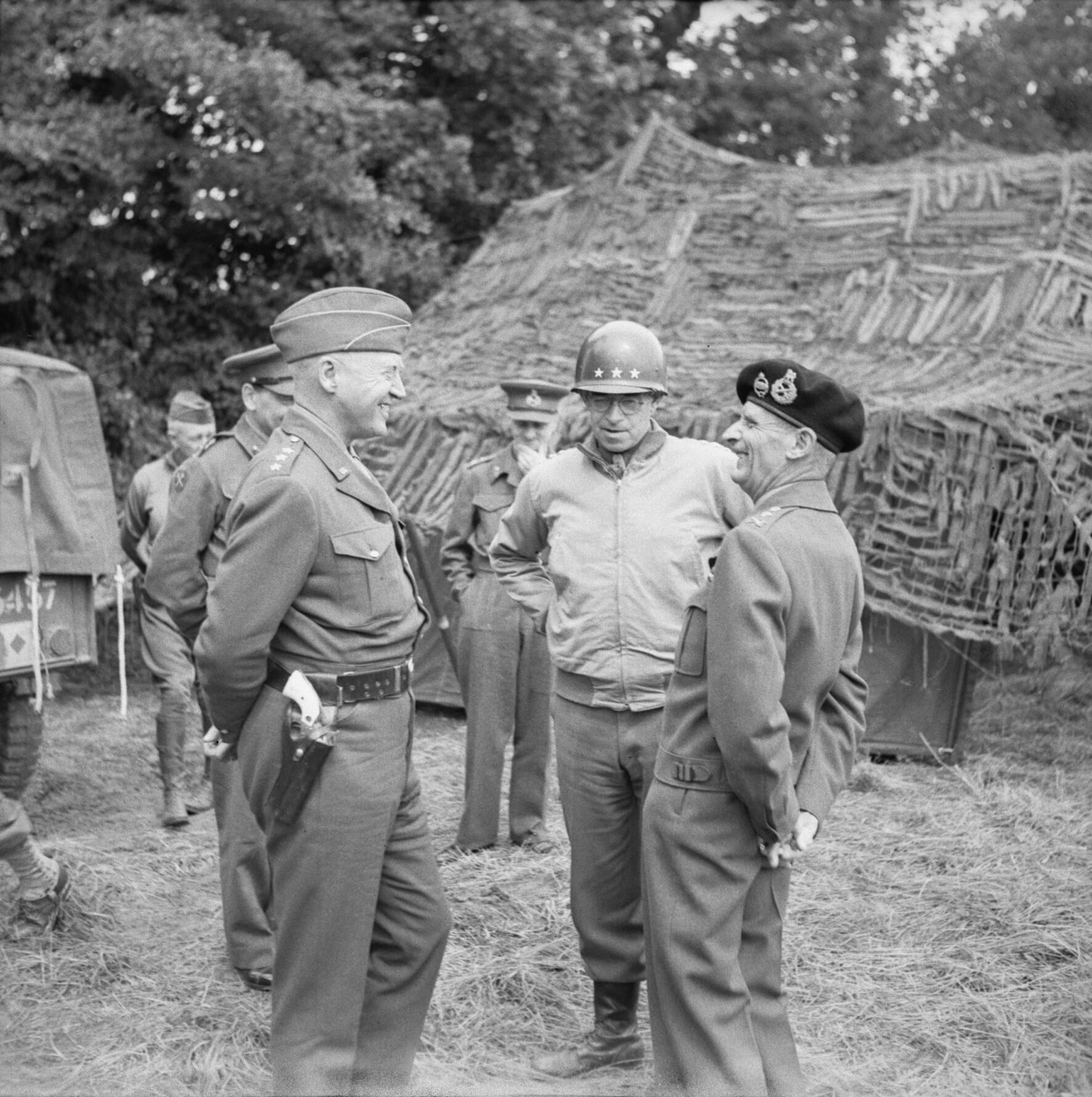 Generals George Patton, Omar Bradley, and Bernard Montgomery meeting at Montgomery’s headquarters at Blay, Normandy, France, 7 Jul 1944. Patton and Montgomery seem to be enjoying a tense laugh.