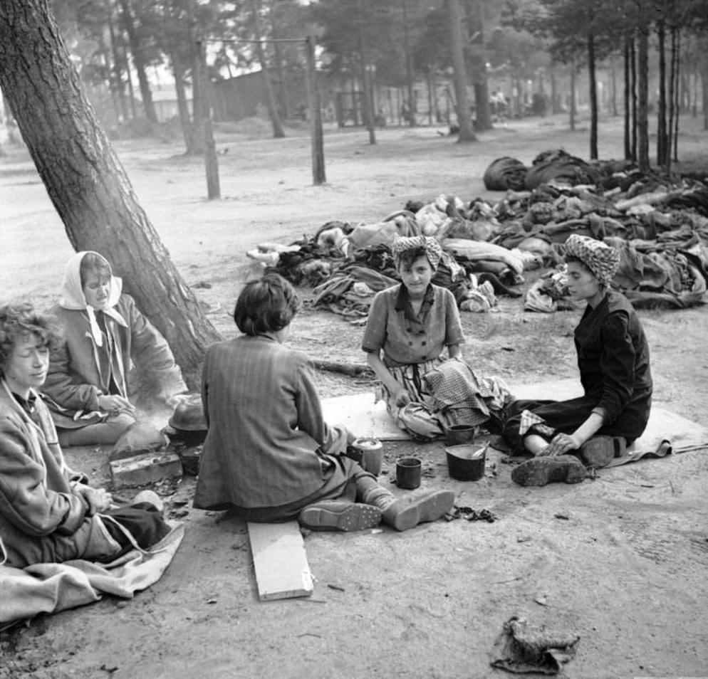 Women prisoners at the Bergen-Belsen Concentration Camp preparing food in the open air with scores of rotting corpses all around them, 17 Apr 1945 (food provided by the British). Photo 1 of 3.