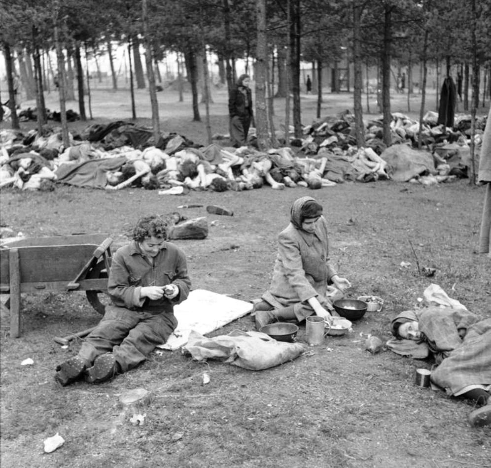 Women prisoners at the Bergen-Belsen Concentration Camp preparing food in the open air with scores of rotting corpses all around them, 17 Apr 1945 (food provided by the British). Photo 3 of 3.