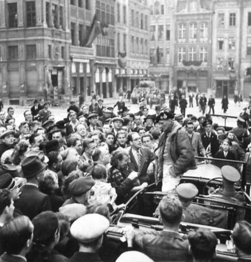 Field Marshal Bernard Montgomery talking to townspeople outside the Town Hall in Louvain, Belgium, 15 Sep 1944. In 1940, Louvain was the front line of Montgomery’s troops against the German Blitzkrieg.