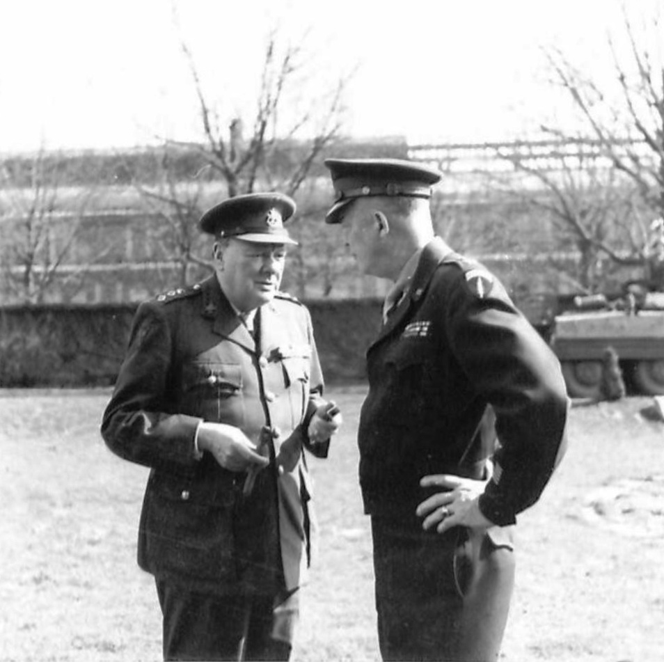British Prime Minister Winston Churchill and Supreme Allied Commander Dwight Eisenhower in conversation at the American XVI Corps headquarters, 25 Mar 1945. Note M8 Greyhound in background.