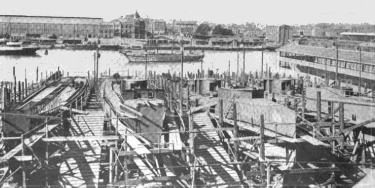Torpedo boat slips, Germaniawerft yard, Kiel, Germany, date unknown; note downtown Kiel in background