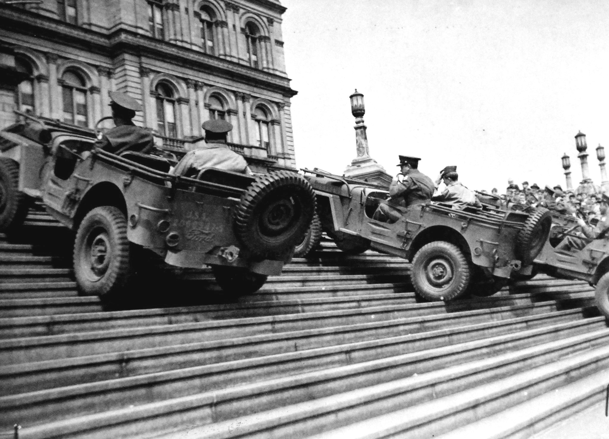 In a public relations event, three Jeeps climb the steps of the State Capitol building, Albany, New York, United States, 15 Apr 1942.