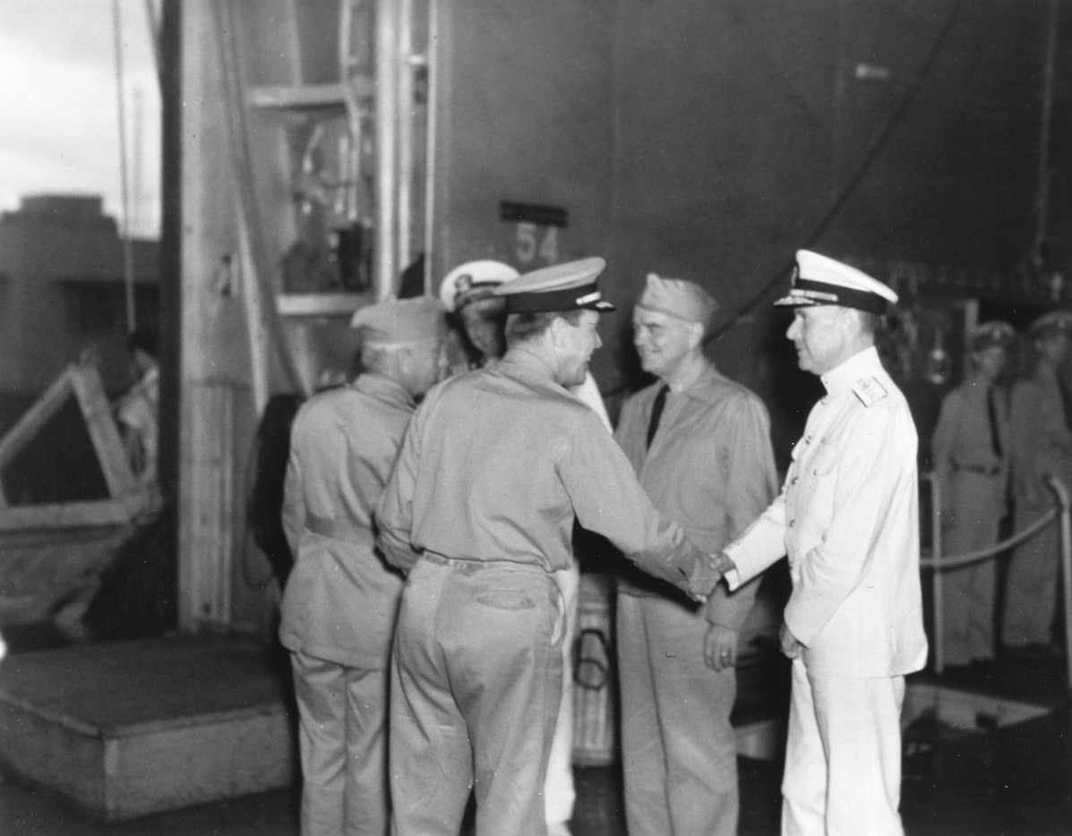 Flag officers aboard USS Enterprise being welcomed back to Pearl Harbor, Hawaii 5 Feb 1942 after the Marshalls-Gilberts Raids. VAdm William Halsey (center) with RAdm’s Aubrey Fitch and Raymond Spruance at each end.