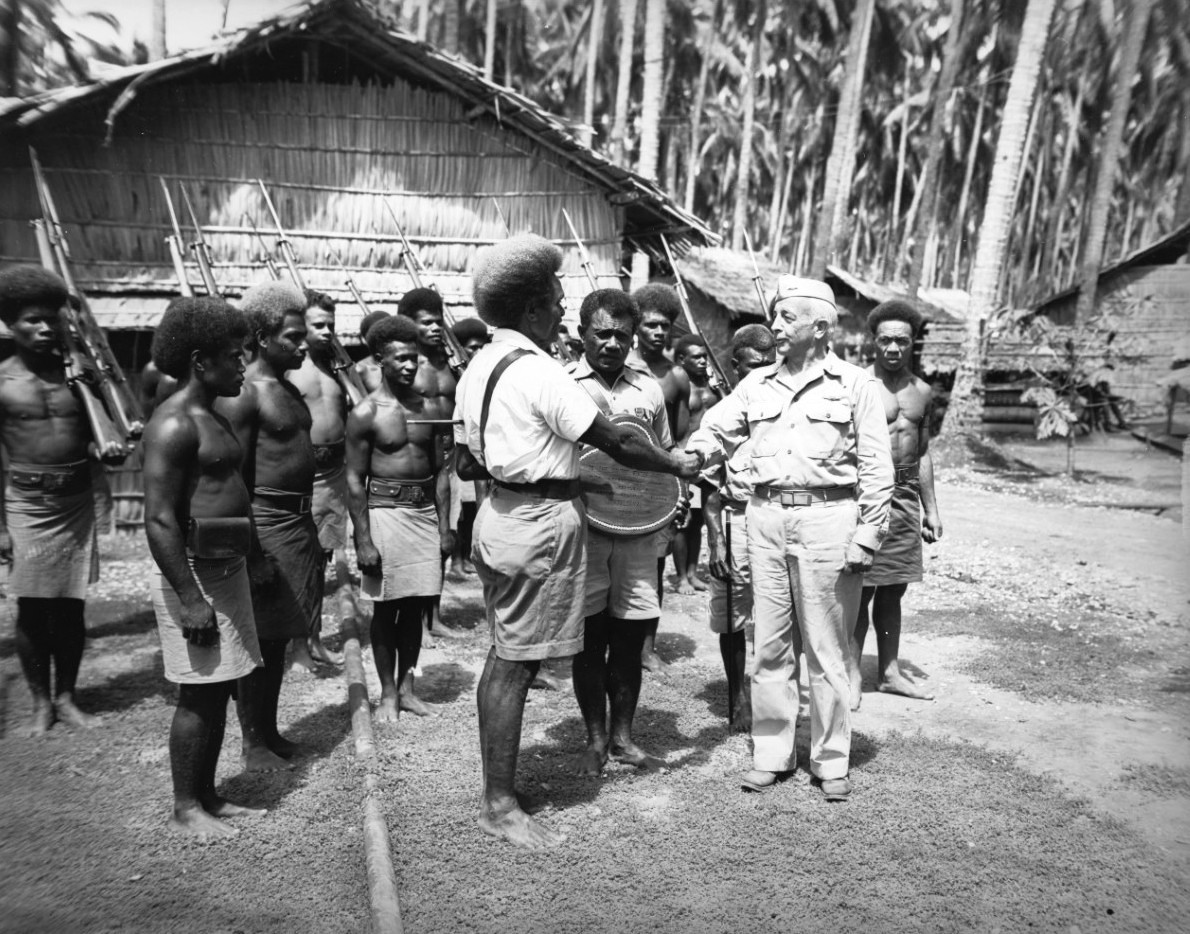 On behalf of the United States Navy, Vice Admiral Aubrey Fitch receives a plaque from appreciative Solomon Islanders on Guadalcanal, 25 Jan 1944.