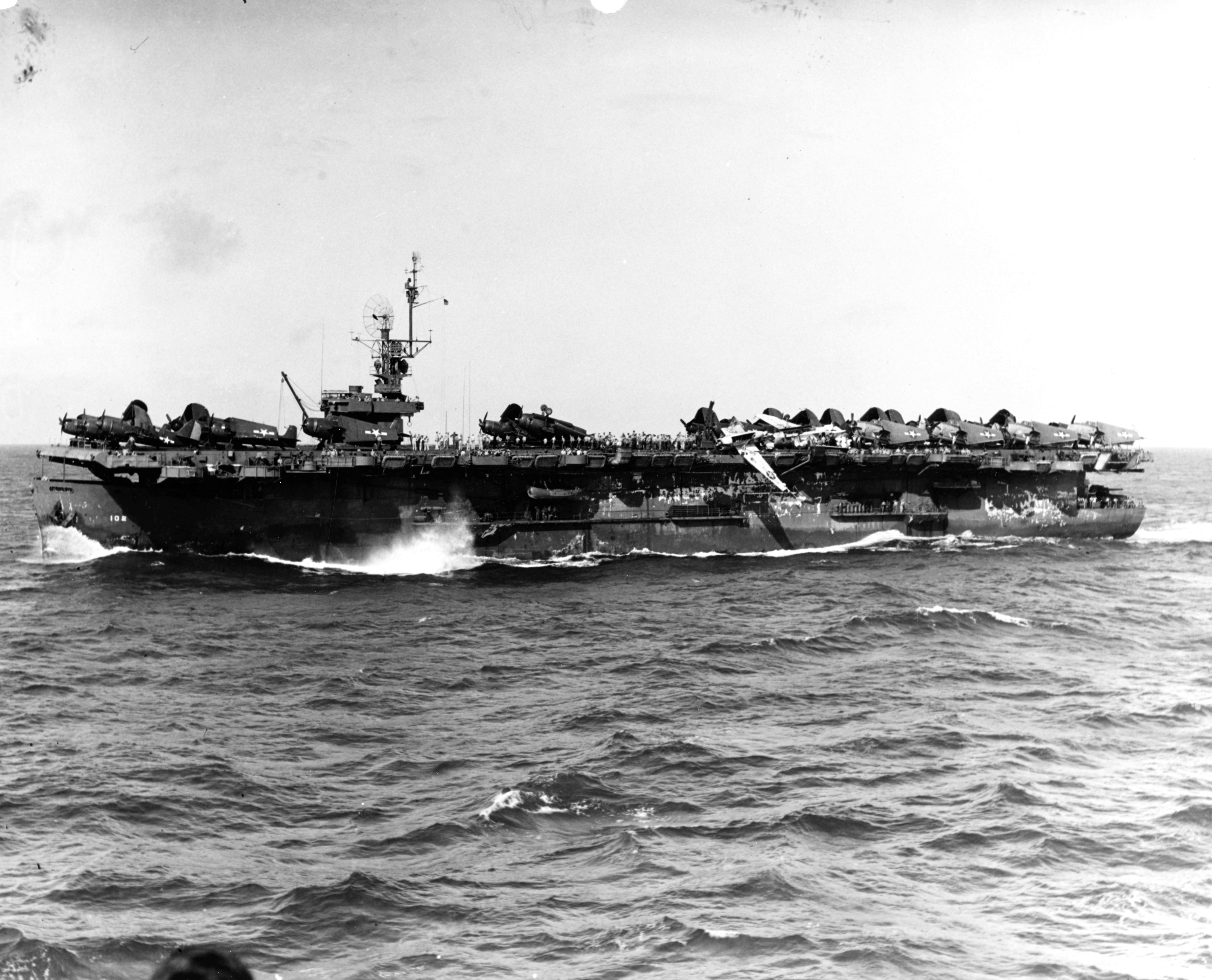 Escort carrier USS Attu the morning after riding out a punishing typhoon that scattered aircraft all over the flight deck and washed 3 aircraft overboard, 5 Jun 1945.
