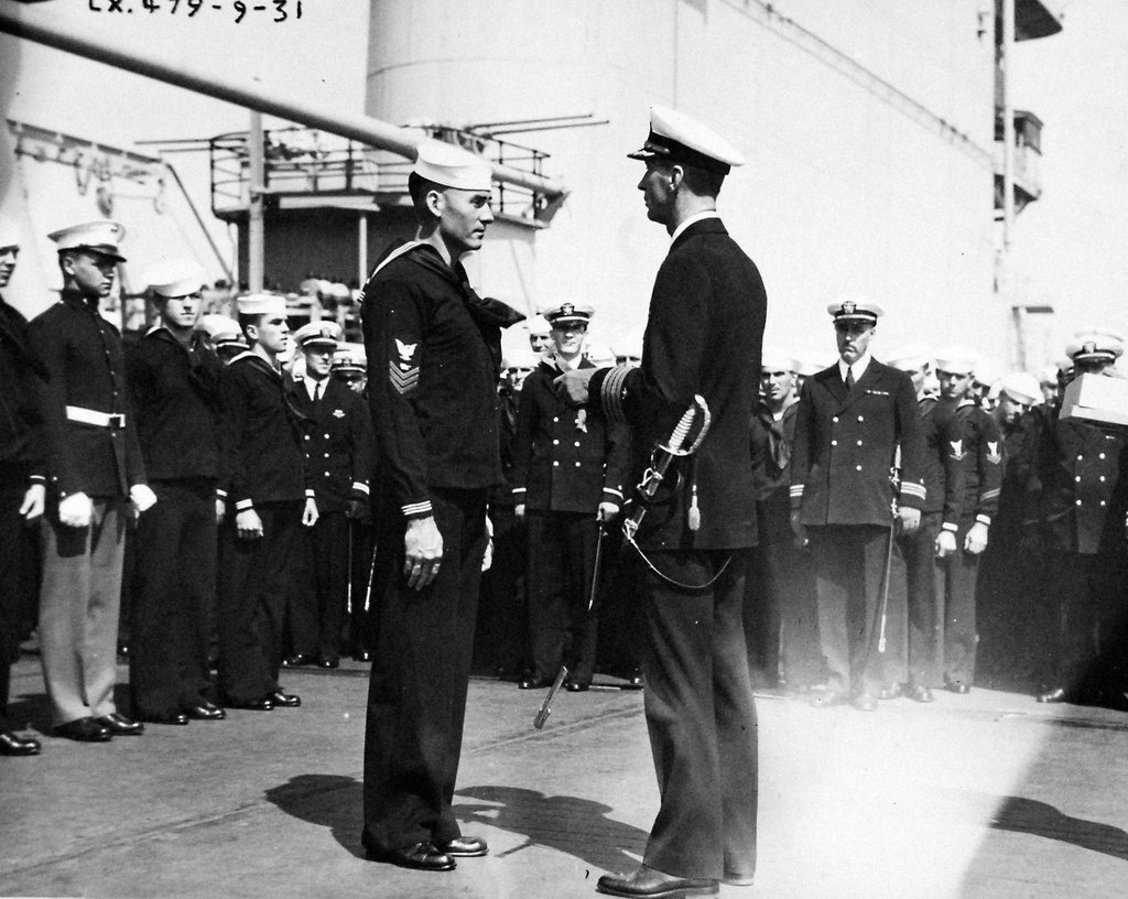 Ernest King, Captain of the USS Lexington (Lexington-class), making a presentation of cigarette cases to members of a Navy racing boat crew, 5 Sep 1931, probably at San Pedro, California.