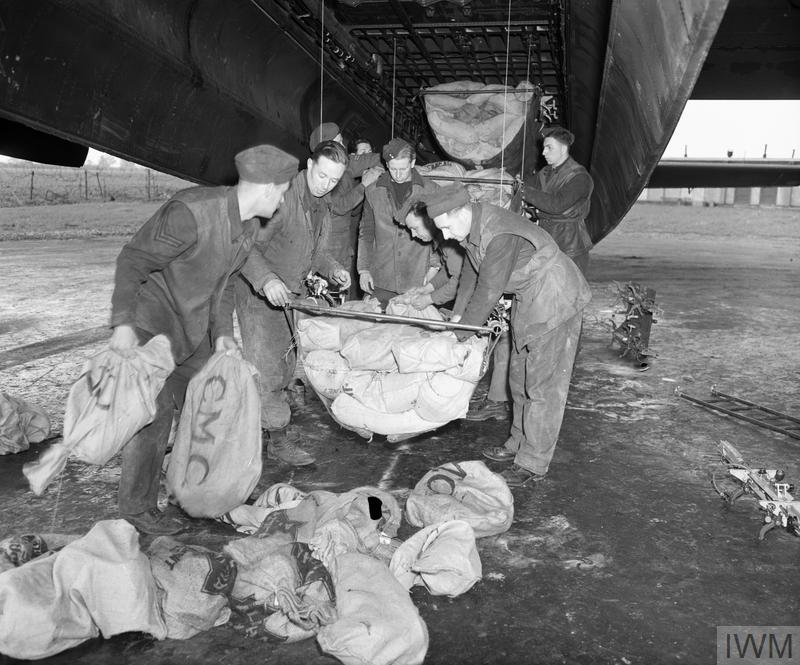 Groundcrew of No. 514 Squadron of Lancaster bombers at Waterbeach, Cambridgeshire, England loading food parcels into an airplane’s bomb bay for dropping on the Netherlands during Operation Manna, May 1945.