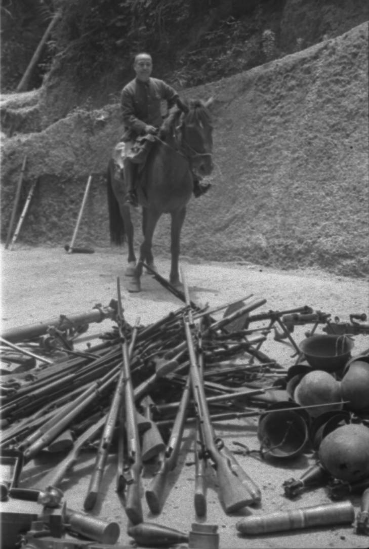 Mounted Chinese officer with captured Japanese equipment, Hubei Province, China, 1942, photo 1 of 2; note Arisaka Type 38 rifles, Type 96 machine gun, and other unidentified equipment