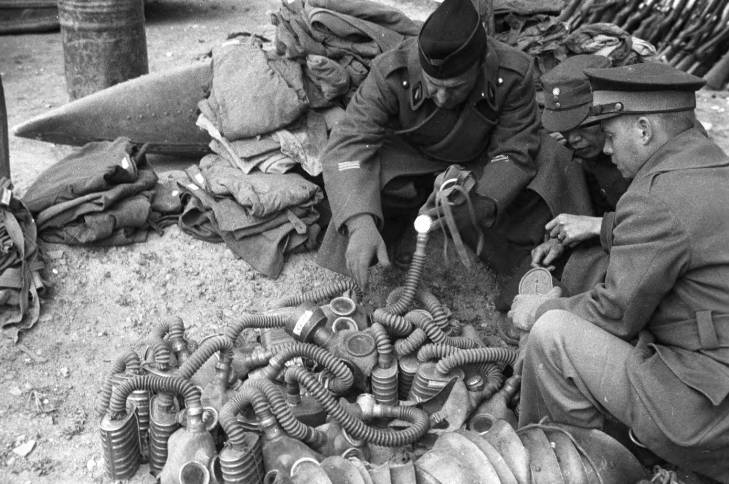 Chinese and foreign officers inspecting captured Belgian-made AG20 gas masks with AGM filters, Changde, Hunan Province, China, 25 Dec 1943; AG20 masks were imported by China, thus these masks must had been captured by the Japanese and re-captured by the Chinese