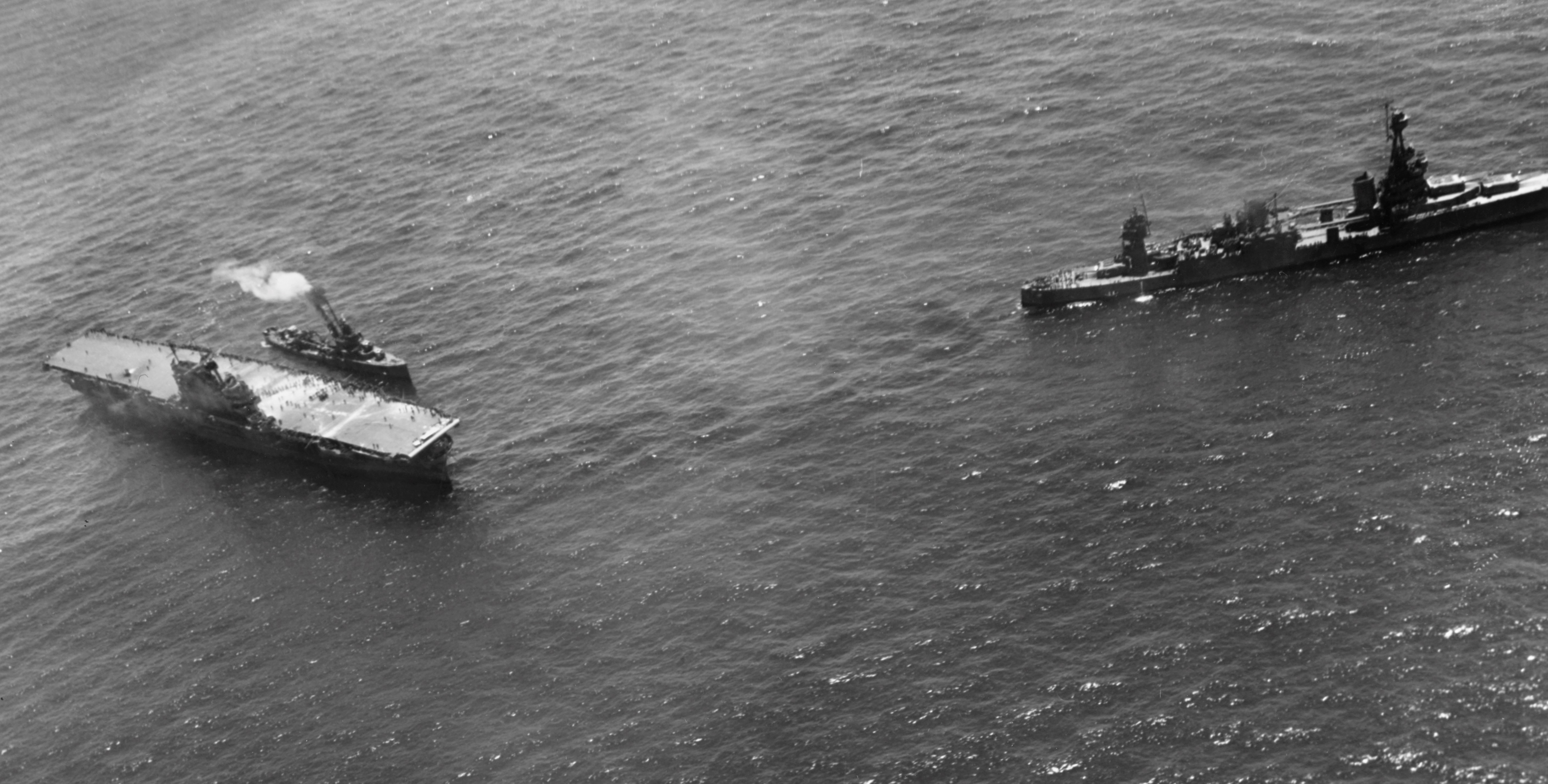 Destroyer USS Russell coming alongside the stricken USS Hornet (Yorktown-class) with cruiser USS Northampton standing off (right), Battle of Santa Cruz Islands, 26 Oct 1942. Photo 2 of 2.