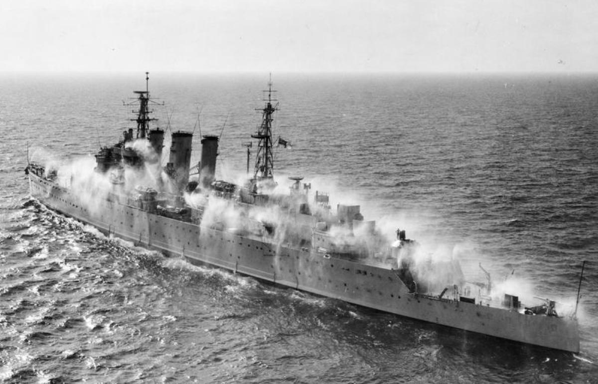 Trials Cruiser HMS Cumberland off Malta in pre-wetting experiments designed to keep radioactive fallout particles from adhering to a ship’s surfaces, Sep 1955.