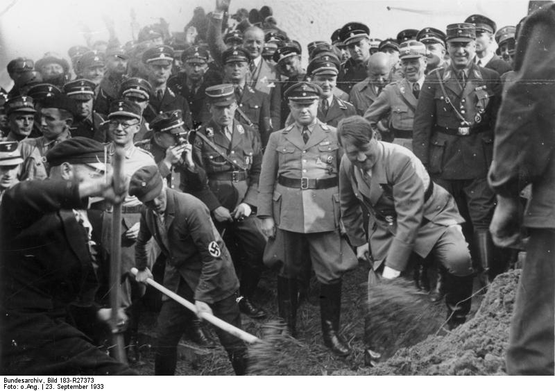 Adolf Hitler at the groundbreaking ceremony of the Reichsautobahn project, near Frankfurt, Germany, 23 Sep 1933; note Jakob Sprenger (left), Fritz Todt (right), Adolf Hühnlein (behind Todt) immediately behind Hitler