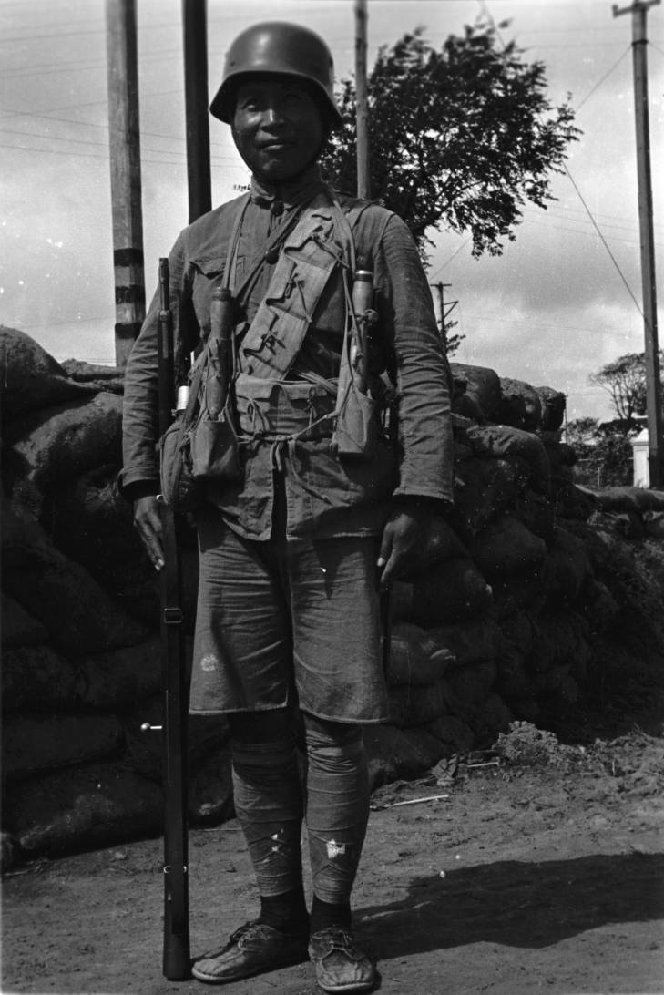 Chinese soldier in Shanghai, China, mid-1937; note Hangyang Type 88 rifle and German-made helmet and grenades