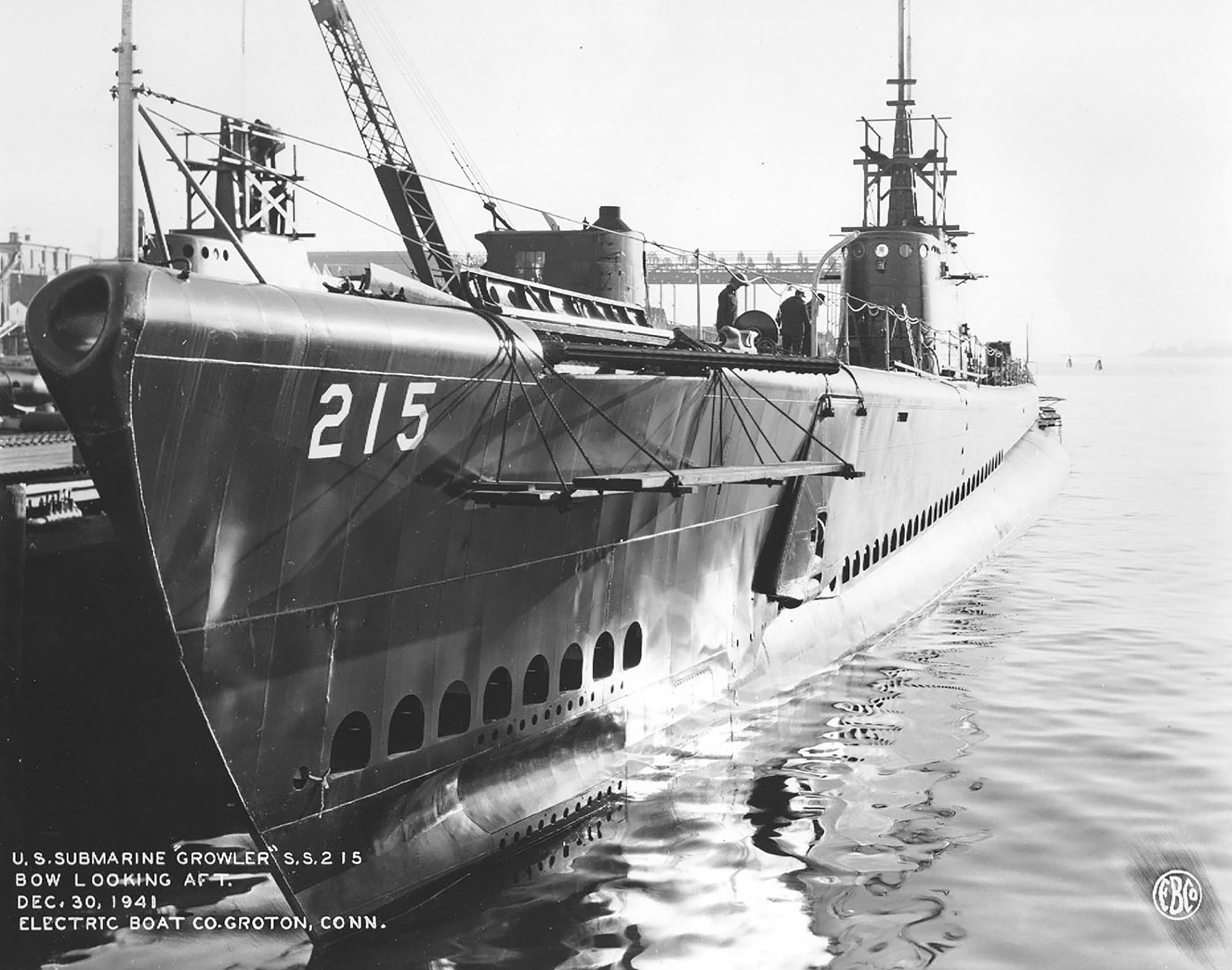Submarine Growler at the fitting out piers at the Electric Boat Company, Groton, Connecticut, United States, 30 Dec 1941. Note Growler’s extended mine cutting gear above the suspended wooden planks.