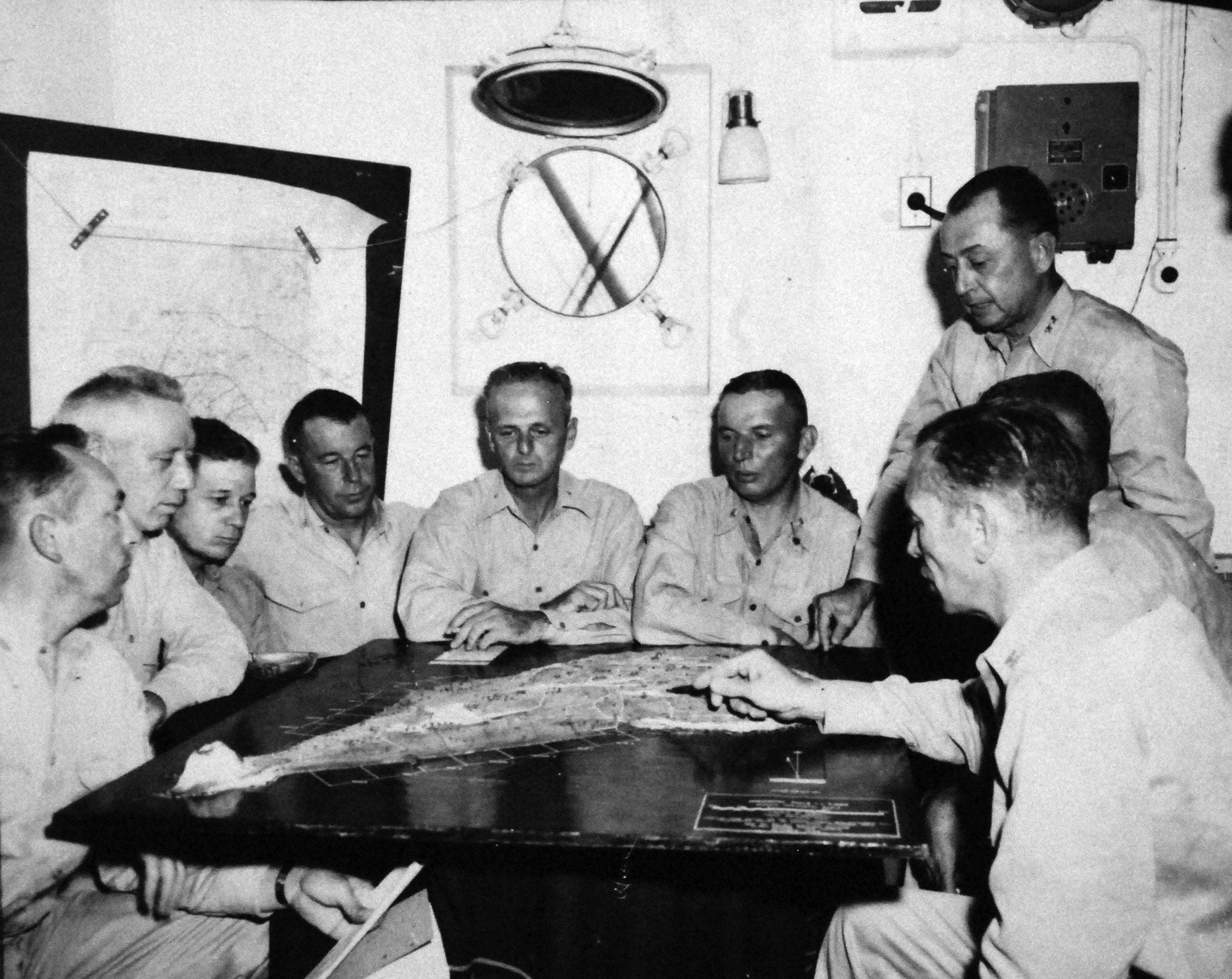 Clifton Cates in conference with his staff officers and regimental commanders, aboard a ship off Iwo Jima, Japan, Feb-Mar 1945