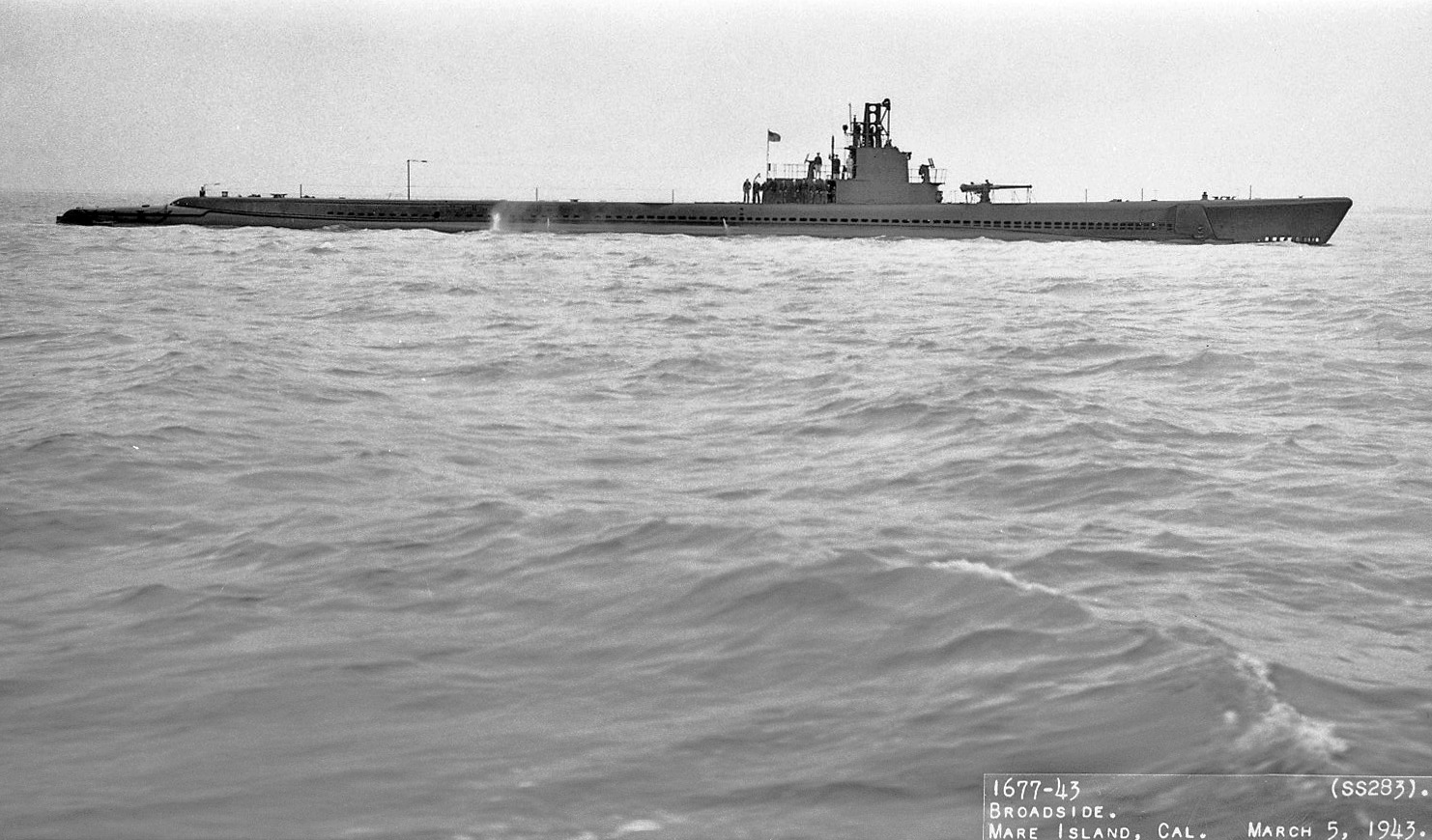 Broadside view of submarine USS Tinosa off Mare Island Navy Yard, San Pablo Bay, California, United States, 5 Mar 1943.