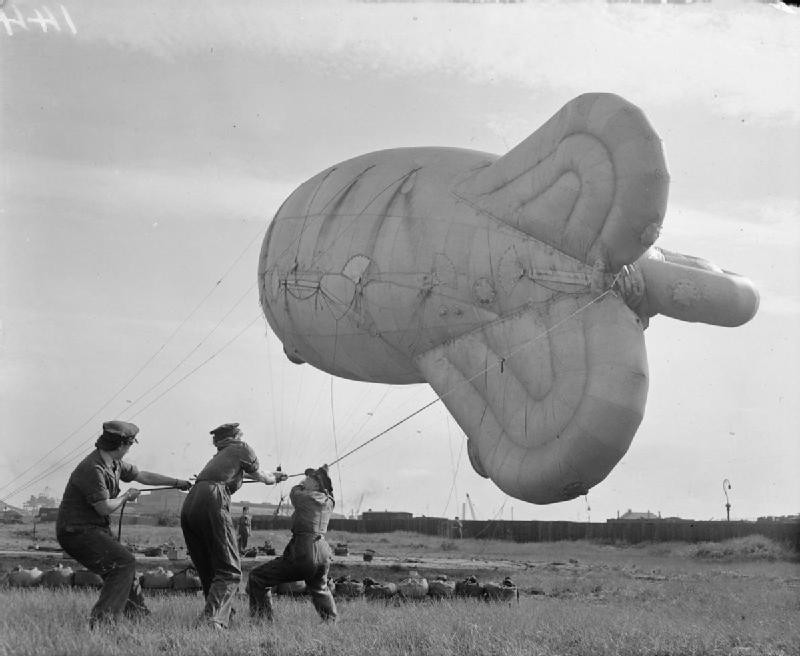 WAAF personnel hauling in a kite balloon at a coastal site, United Kingdom, 1940s