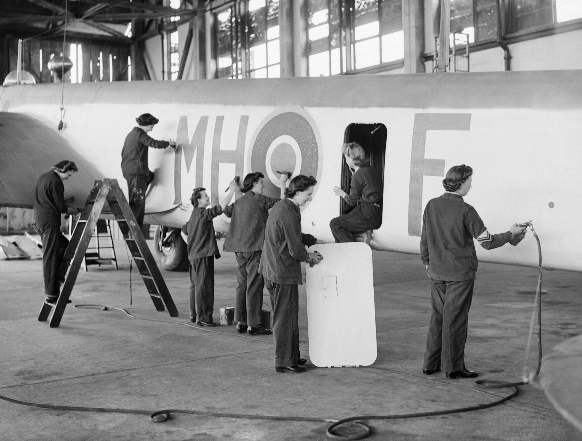 WAAF fabric workers and workshop hands at a RAF Coastal Command Maintenance Unit cleaning and painting a Whitley Mark V bomber of No. 51 Squadron RAF, RAF Gosport, Hampshire, England, United Kingdom, date unknown