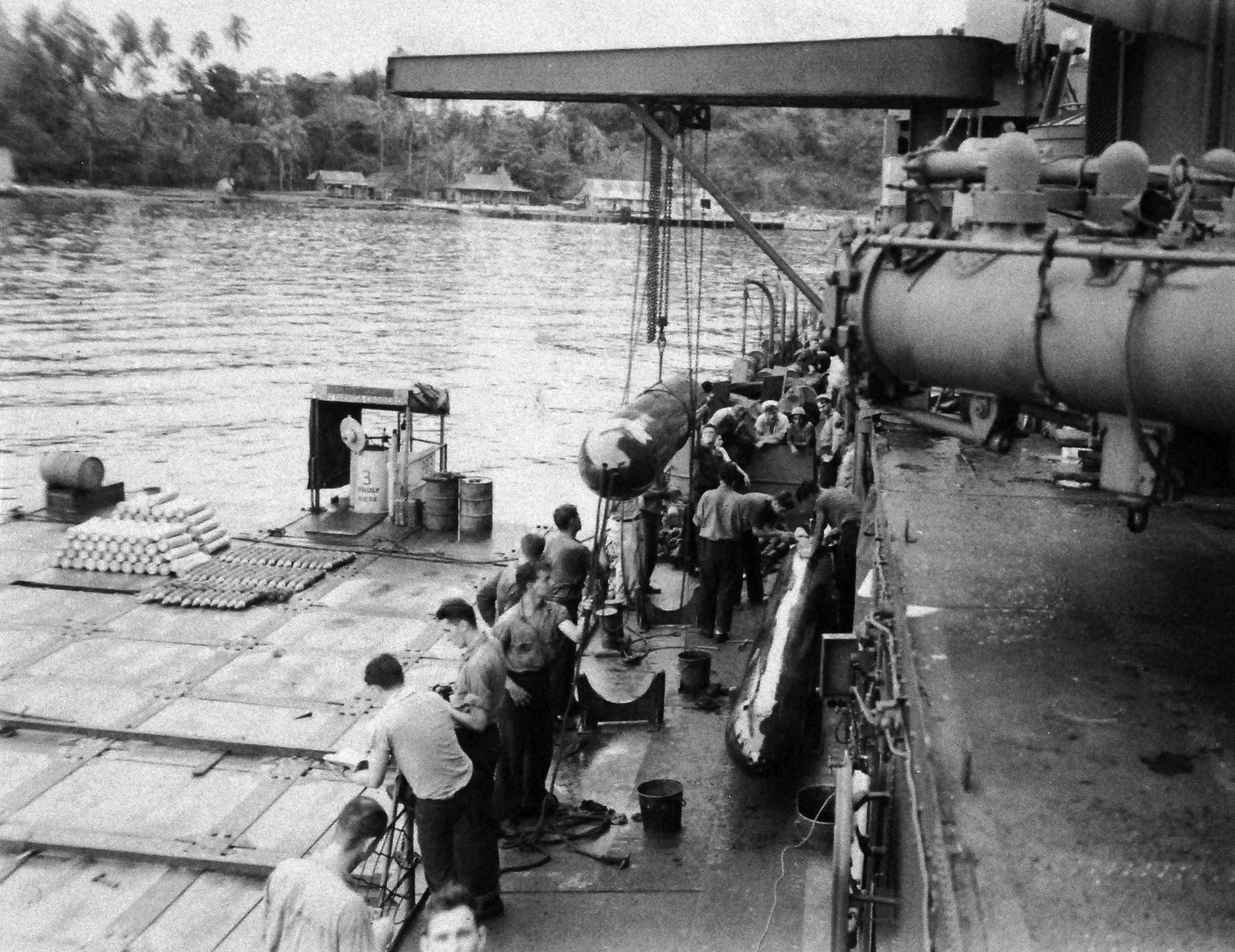 Mark XV torpedoes being transferred to the USS Nicholas from the USS Patterson at Tulagi, Solomon Islands, 14 Jul 1943 following the Battle of Kolombangara. Photo 1 of 2.