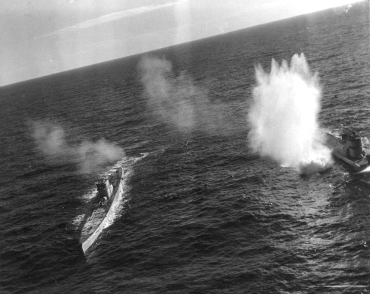 German submarines U-66 (left) and U-117 were caught on the surface in the mid-Atlantic by a coordinated attack by TBF-1 Avengers and F4F Wildcats flying from USS Card, 7 Aug 1943. U-117 was sunk in the attack.