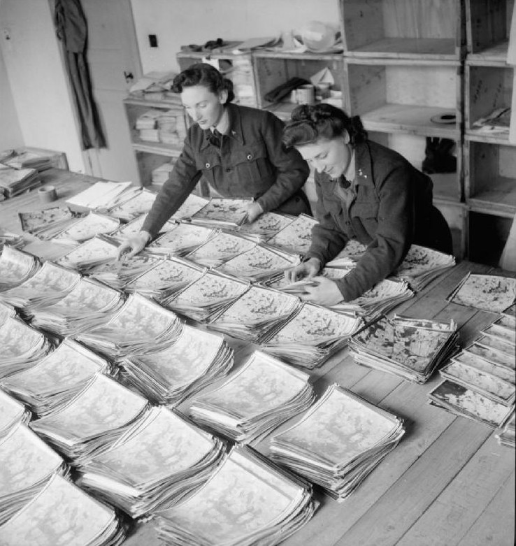 WAAF Leading Aircraftwomen Ida Brown and Mary Jordan preparing prints for despatch in the sorting room of RAF Second Tactical Air Force Photographic Negative Library at Keerbergen, Belgium, 1945