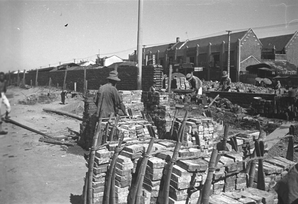 Laborers building a brick defensive wall in the French Concession Zone, Shanghai, China, mid-1937