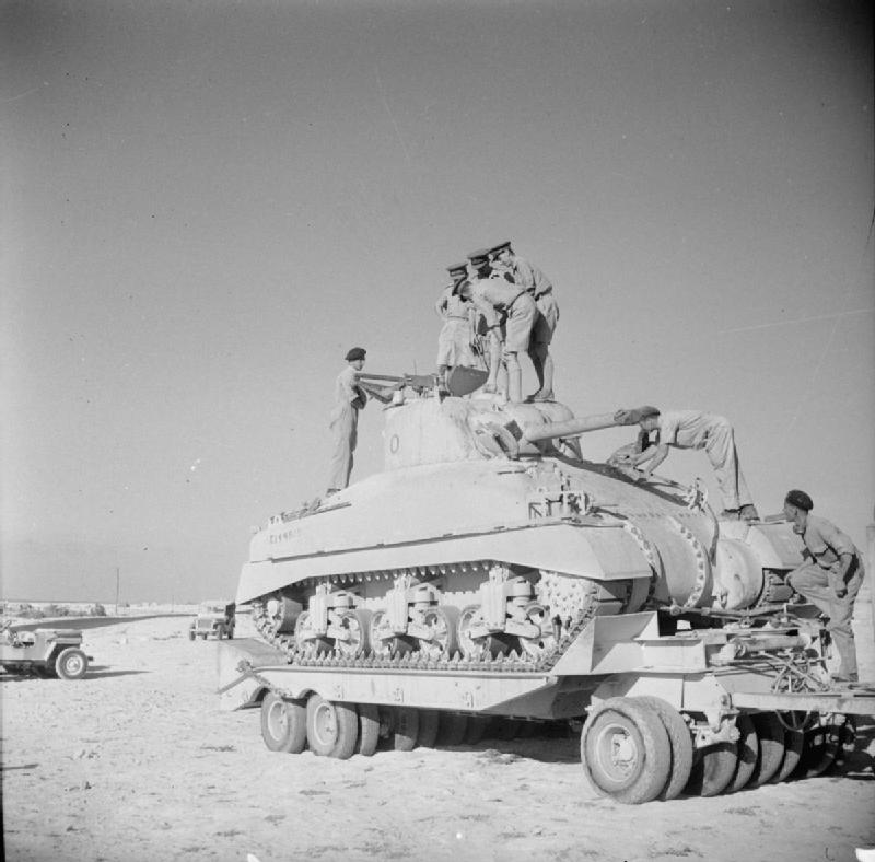 British staff officers inspecting a newly arrived Sherman tank on a trailer, North Africa, 15 Sep 1942
