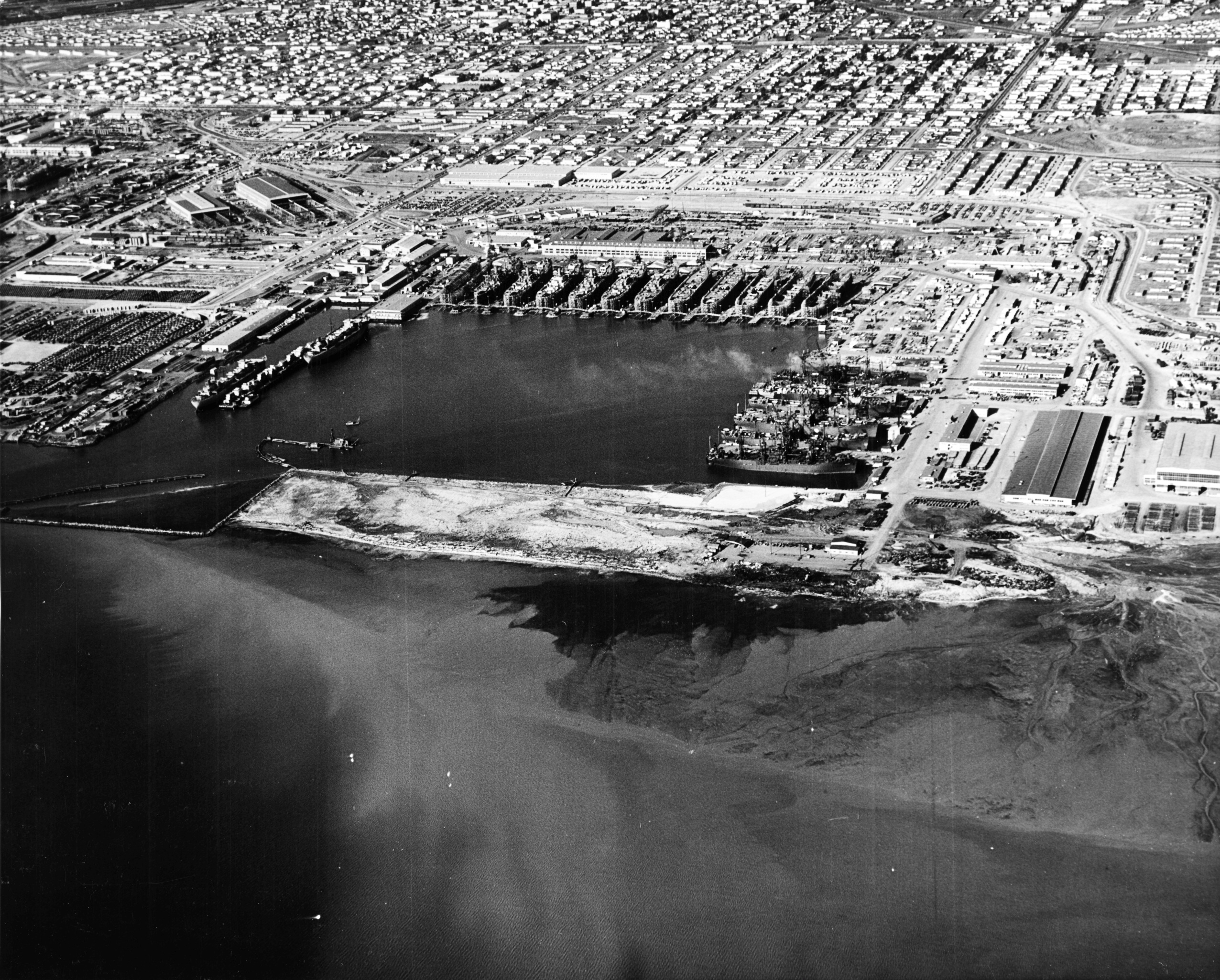 Aerial view of Permanente Metals Shipyard No. 2 looking north, Richmond, California, United States, 11 Dec 1944. Note the prefabrication sheds on the left angled 45-degrees to everything else.