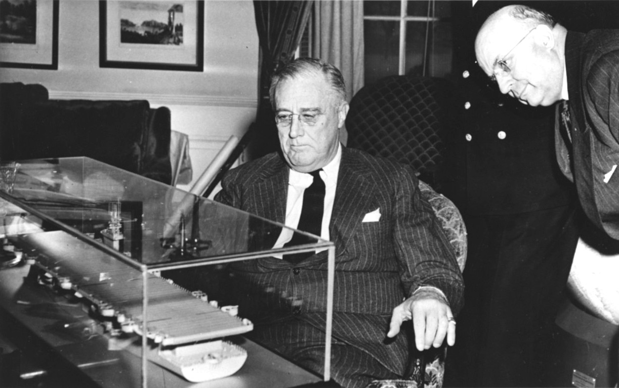 At the White House 18 Mar 1943, Henry Kaiser, right, and President Franklin Roosevelt looking at a model of a Casablanca-class escort aircraft carrier, then under construction at Kaiser’s Vancouver, Washington shipyard.