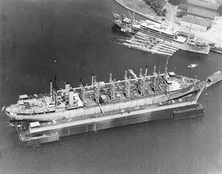 USS Jason (center) at Dewey Drydock, Subic Bay Navy Yard, Olongapo, Philippine Islands, 9 Mar 1932; note USS Canopus at upper right with S-38 (outboard) and three other submarines