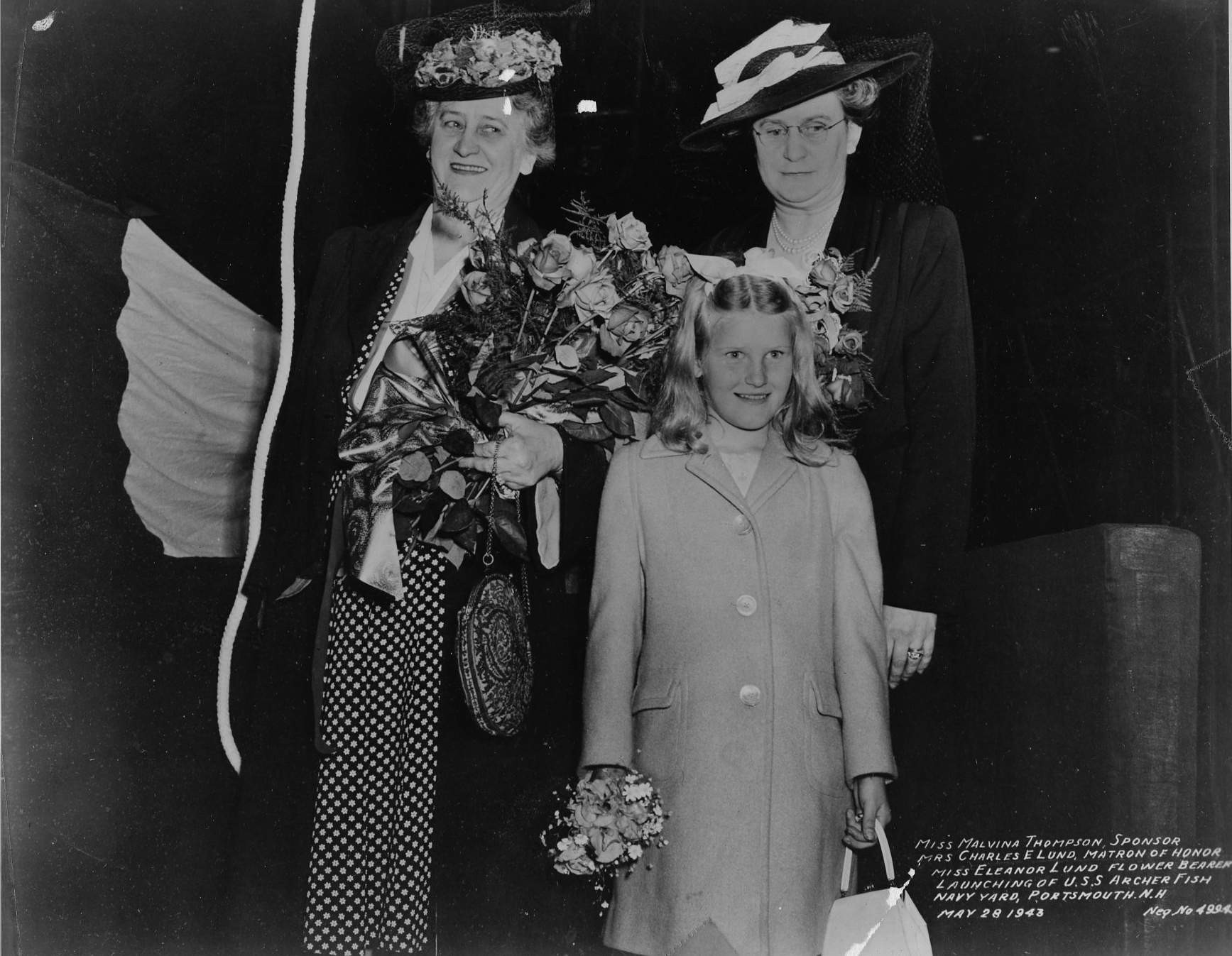 Malvina Thompson (sponsor), Mrs. Charles E. Lund (matron of honor), and Eleanor Lund (flower bearer) at the launching ceremony of Archerfish, Portsmouth Navy Yard, Kittery, Maine, United States, 28 May 1943.