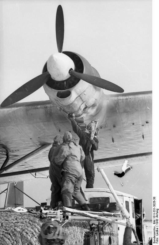 German Air Force mechanic performing maintenance on the outboard engine on the port side wing of a Me 323 Gigant aircraft, Soviet Union, early 1943, photo 2 of 2